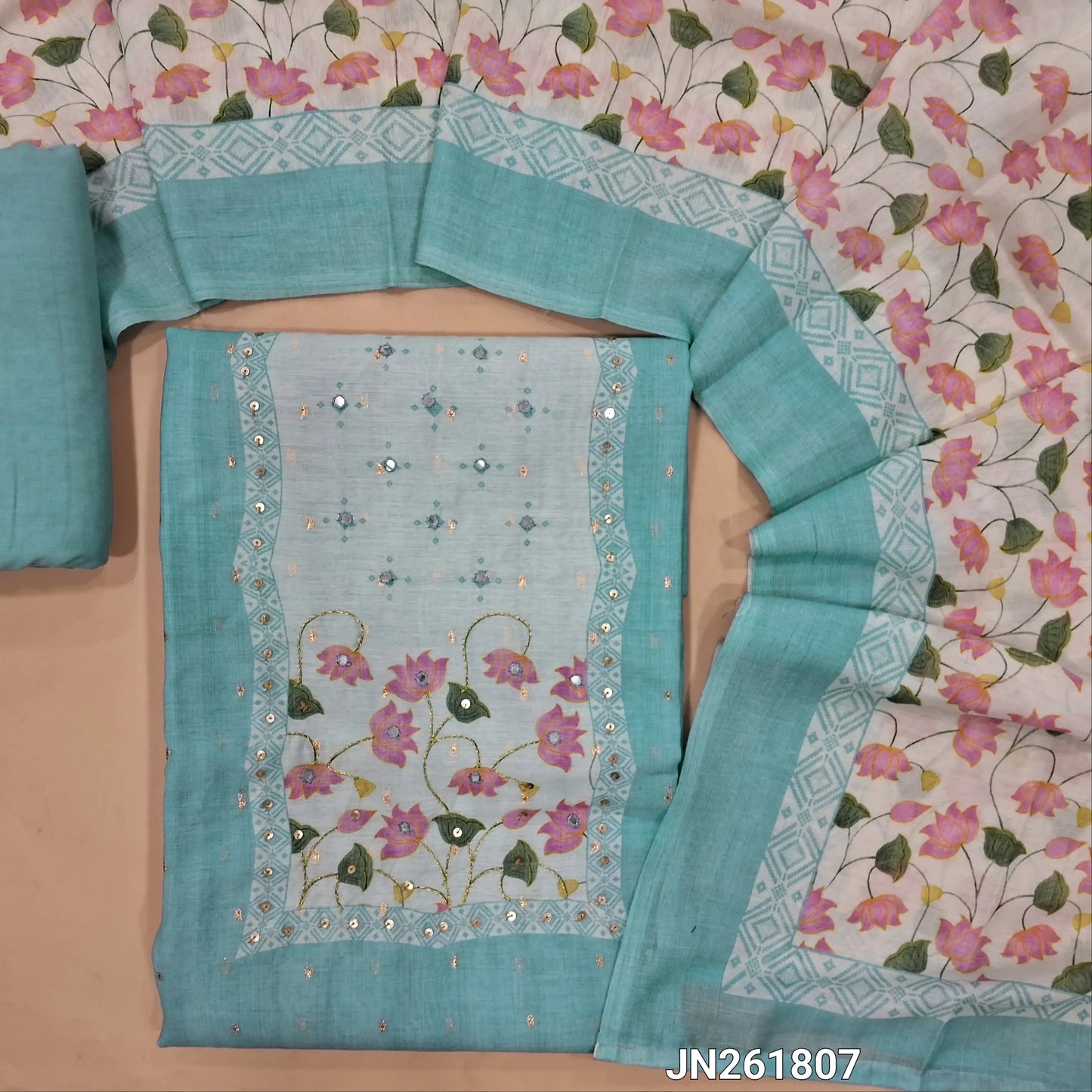 Powder blue soft silk cotton unstitched salwar material(lining needed) sequins & faux mirror work on yoke,zari buttas all over,matching santoon bottom, digital printed soft silk cotton dupatta. JN261807