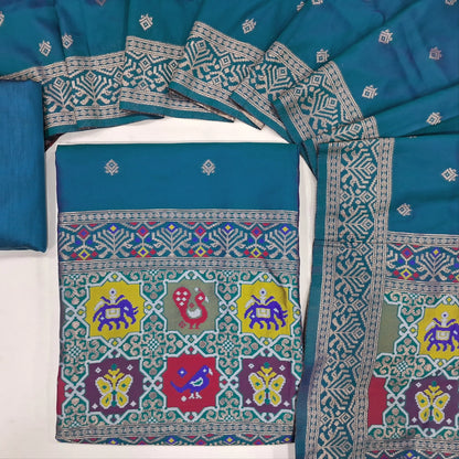 Peacock blue premium silk unstitched salwar material (lining needed) benarasi woven & meenakari weaving on yoke & daman, matching silk cotton bottom, premium silk cotton full length dupatta with meenakari weaving design pallu. JN262101