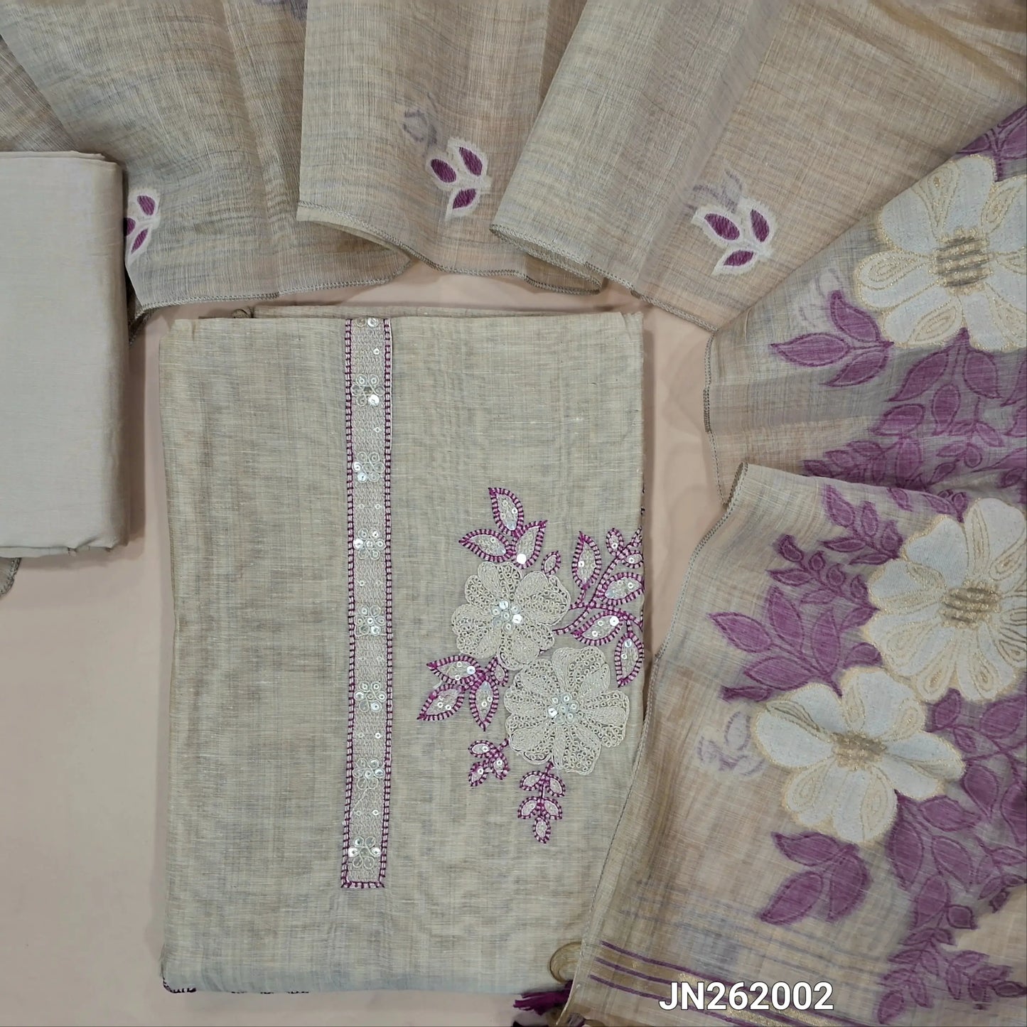 Designer rich beige silk cotton unstitched salwar material,(purple)(lining needed)thread embroidery & sequins work on yoke,matching spun silk cotton bottom,jamdani woven silk cotton dupatta with handmade tessels pallu. JN262002
