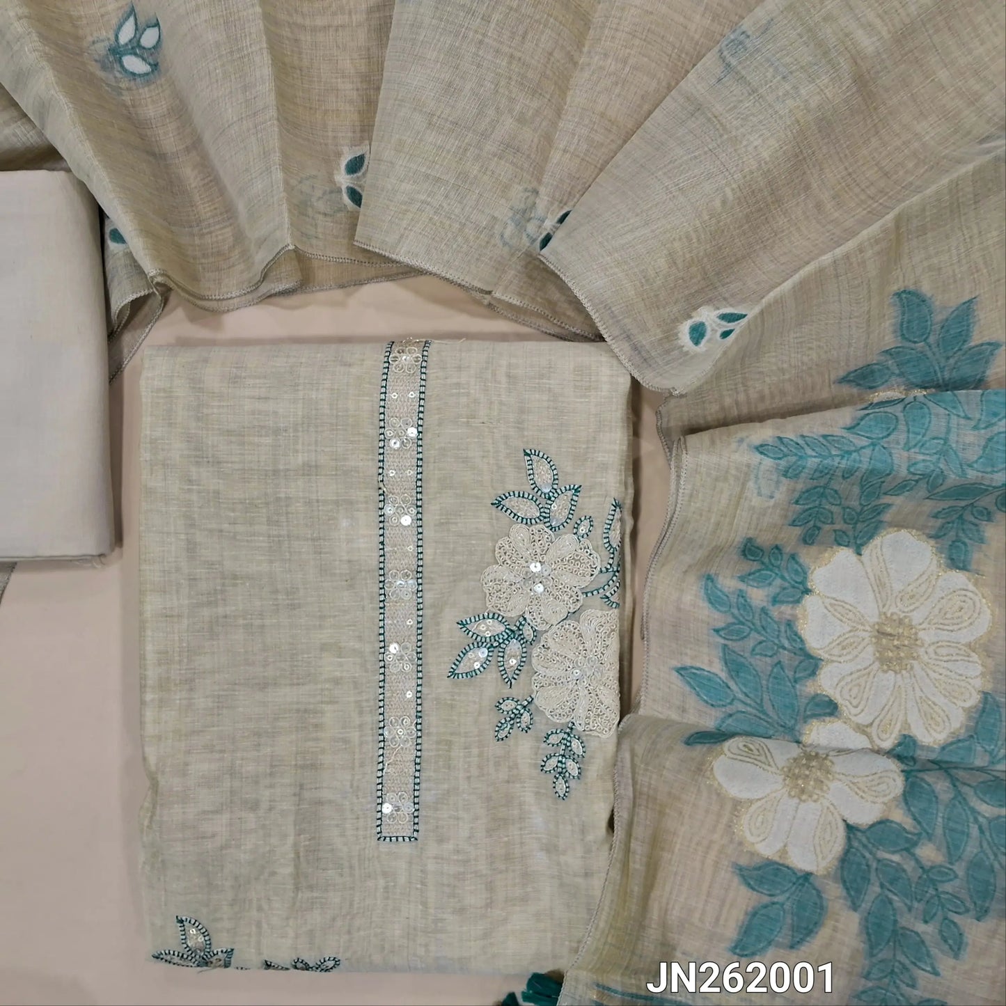 Designer rich beige silk cotton unstitched salwar material,(teal blue)(lining needed)thread embroidery & sequins work on yoke,matching spun silk cotton bottom,jamdani woven silk cotton dupatta with handmade tessels pallu. JN262001