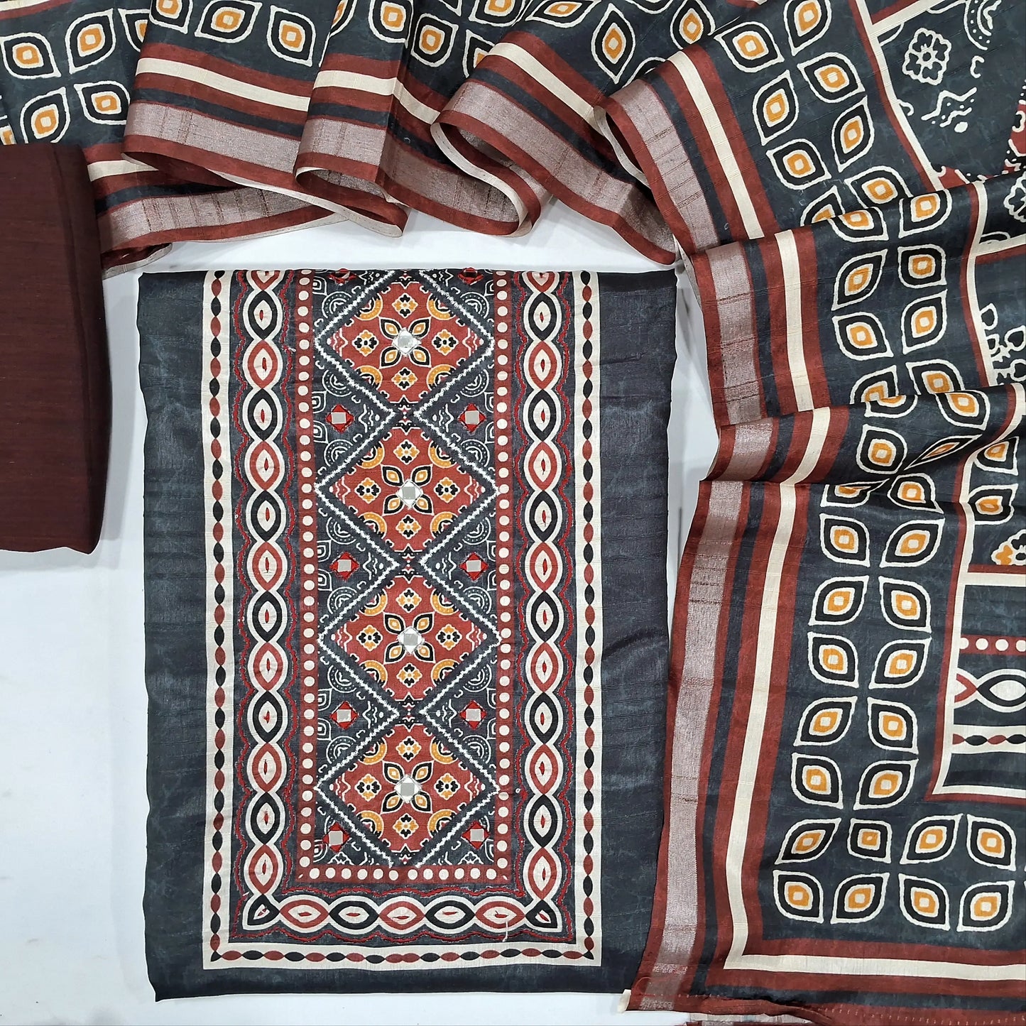 Black semi tussar unstitched salwar material,(texured, lining needed) printed, real mirror work on yoke, maroon silk cotton or cotton bottom, prined semi tussar  full length dupatta. OC251315