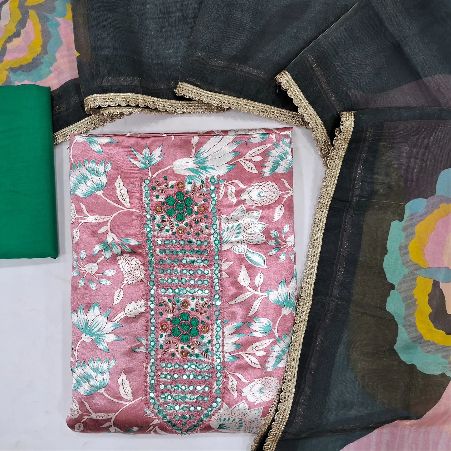 Pastel pink gaiji silk unstitched salwar material ,hand embroidery & faux mirror work on yoke,(shiny,lining needed) matching bottom,multicolor organza silk dupatta with less tapping.JN262123