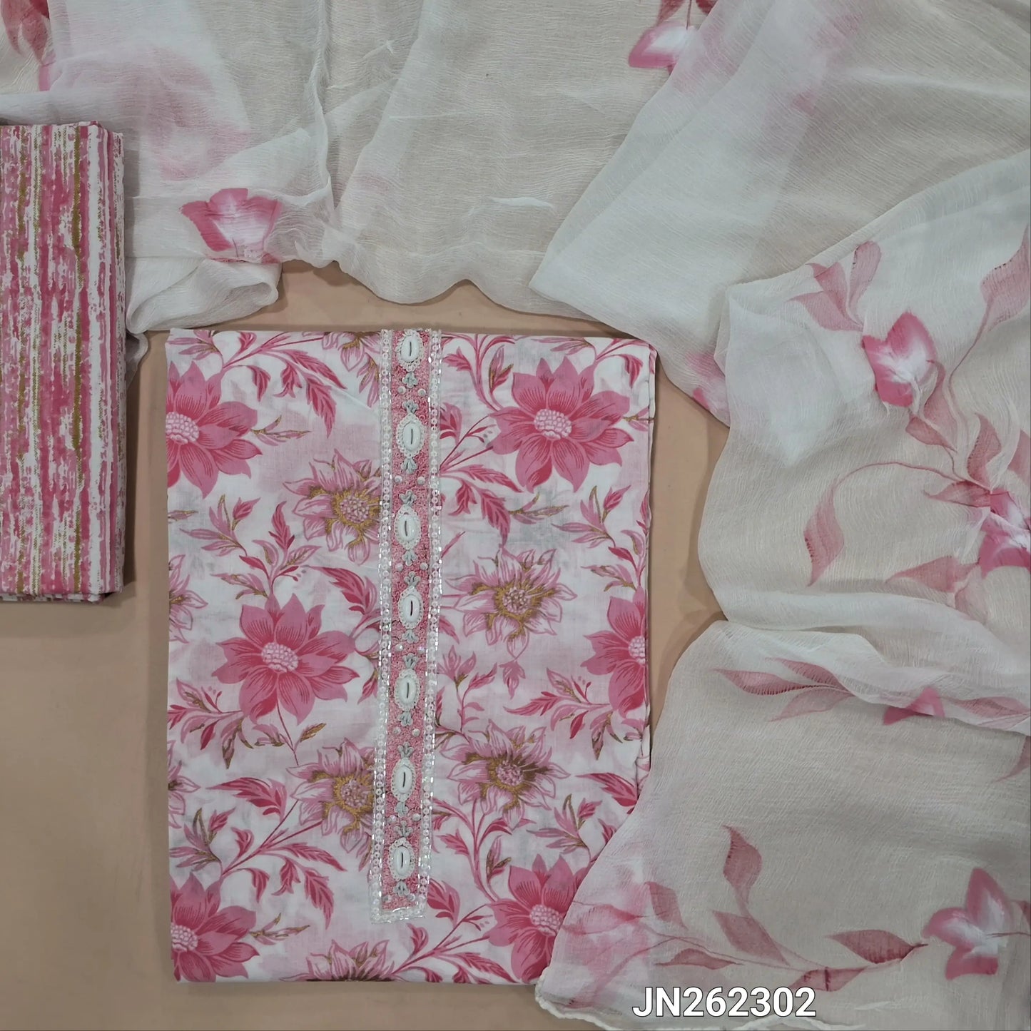 Pink floral printed premium mul cotton unstitched salwar material,fancy shell buttons,cut bead & sequins work on yoke(soft,lining needed)printed cotton bottom,hand brush paint work on pure chiffon dupatta. JN262302