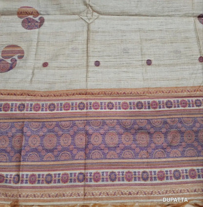 Designer beige premium tussar silk unstitched salwar material,(lining needed)weaving work on yoke,jamdani woven buttas on front & daman, silk cotton bottom, thread jamdani woven on full length tussar silk dupatta with tassels.JN262606