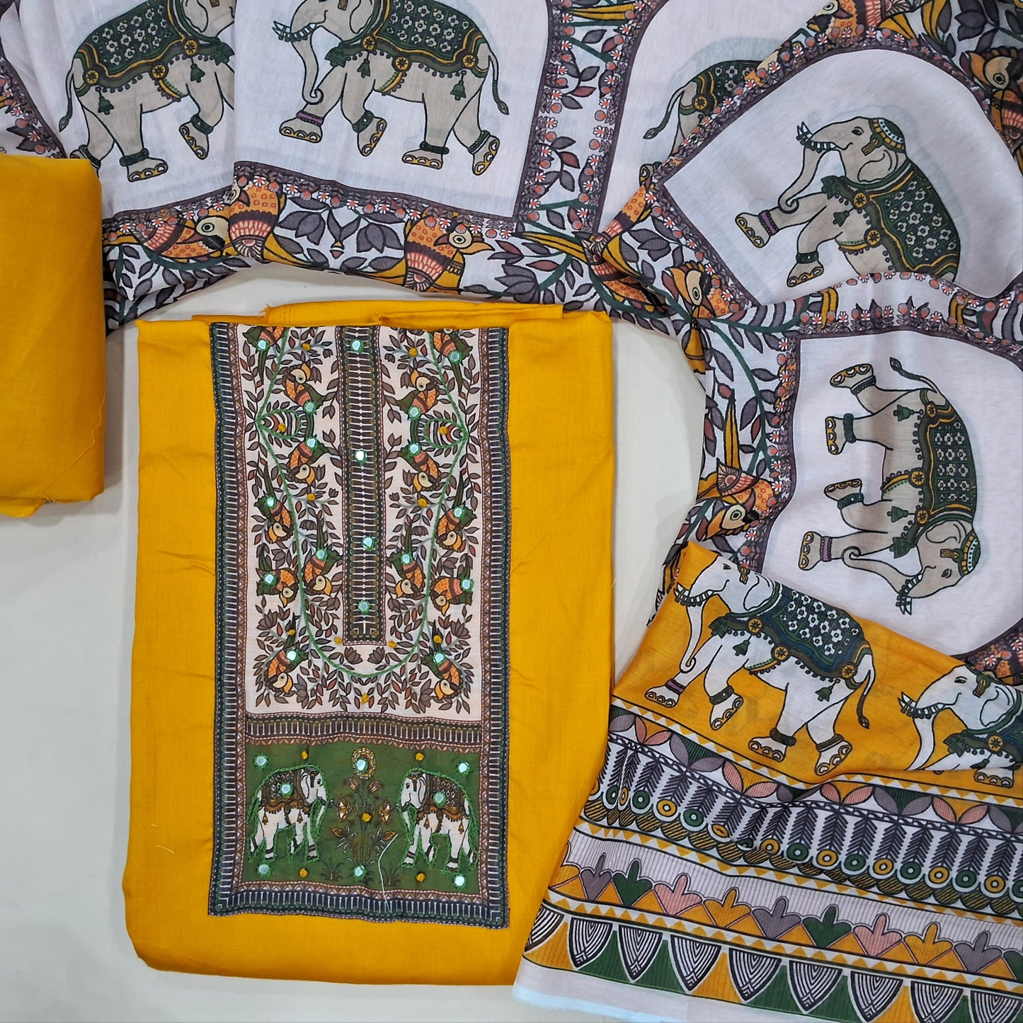 Yellow satin cotton unstitched salwar material, (Lining needed) floral printed and faux mirror work on yoke, cotton bottom, digital printed silk cotton dupatta.(TAPPING NEEDED) JN262814