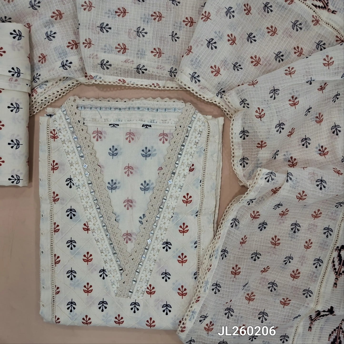 Off white cotton unstitched salwar material,collar neck with real mirror,(maroon and blue)pintex work on front,panel design,(lining needed)schiffli cotton bottom,block printed pure kota cotton dupatta with lace work. JL260206
