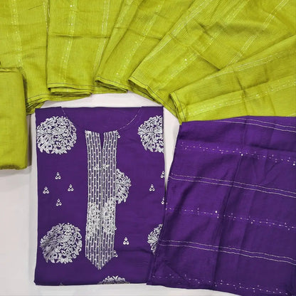 Designer purple semi raw silk unstitched salwar material, zari& sequins work on yoke, floral prints all over(lining optional) bright green silk cotton bottom,zari & sequins work on dual shaded silk cotton dupatta. JL260501