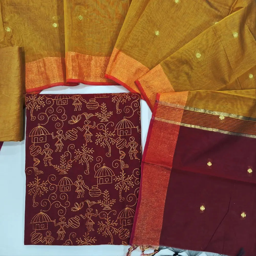 Reddish maroon & yellow warli embroidery chanderi silk cotton unstitched salwar material,thread embroidery work on front (light weight,Lining Needed) silky bottom, dual shaded chanderi silk cotton dupatta with zari buttas and gold tissue borders. JL260503