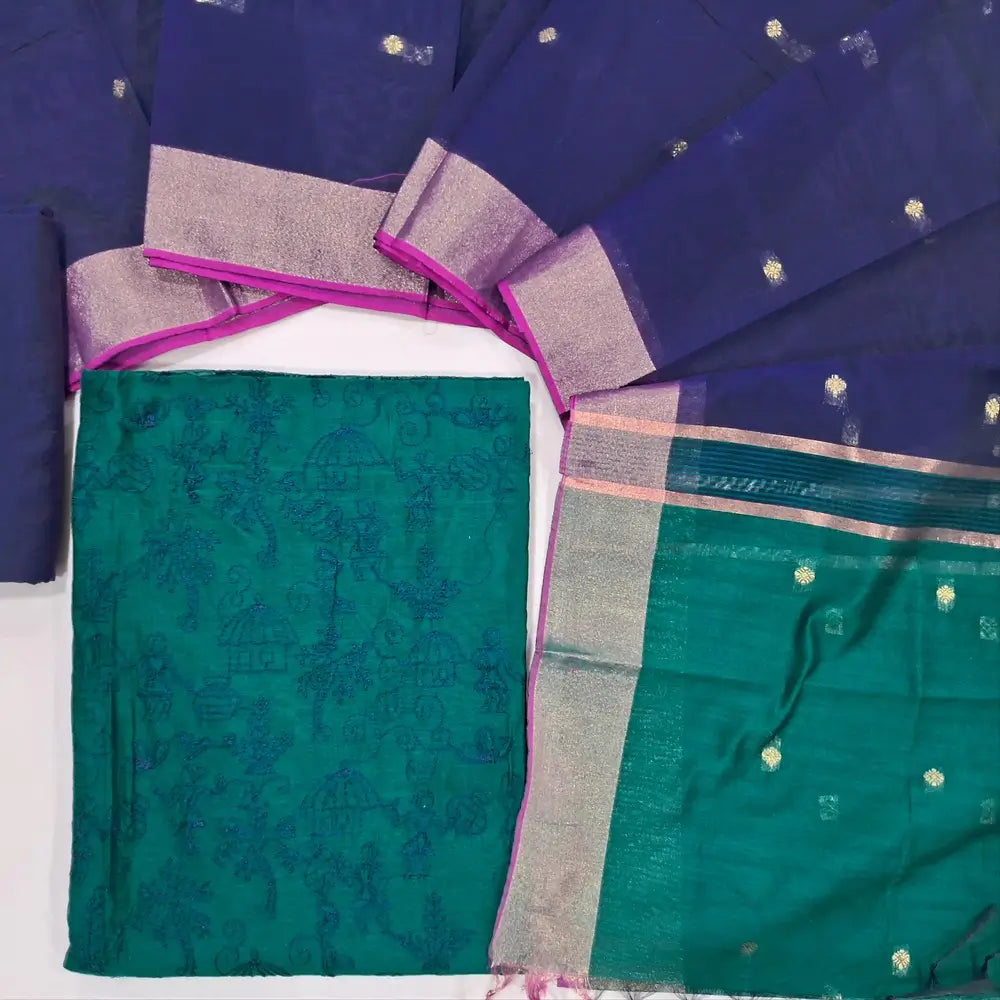 Dark teal & navy blue warli embroidery chanderi silk cotton unstitched salwar material,thread embroidery work on front (light weight,Lining Needed) silky bottom, dual shaded chanderi silk cotton dupatta with zari buttas and gold tissue borders. JL260504
