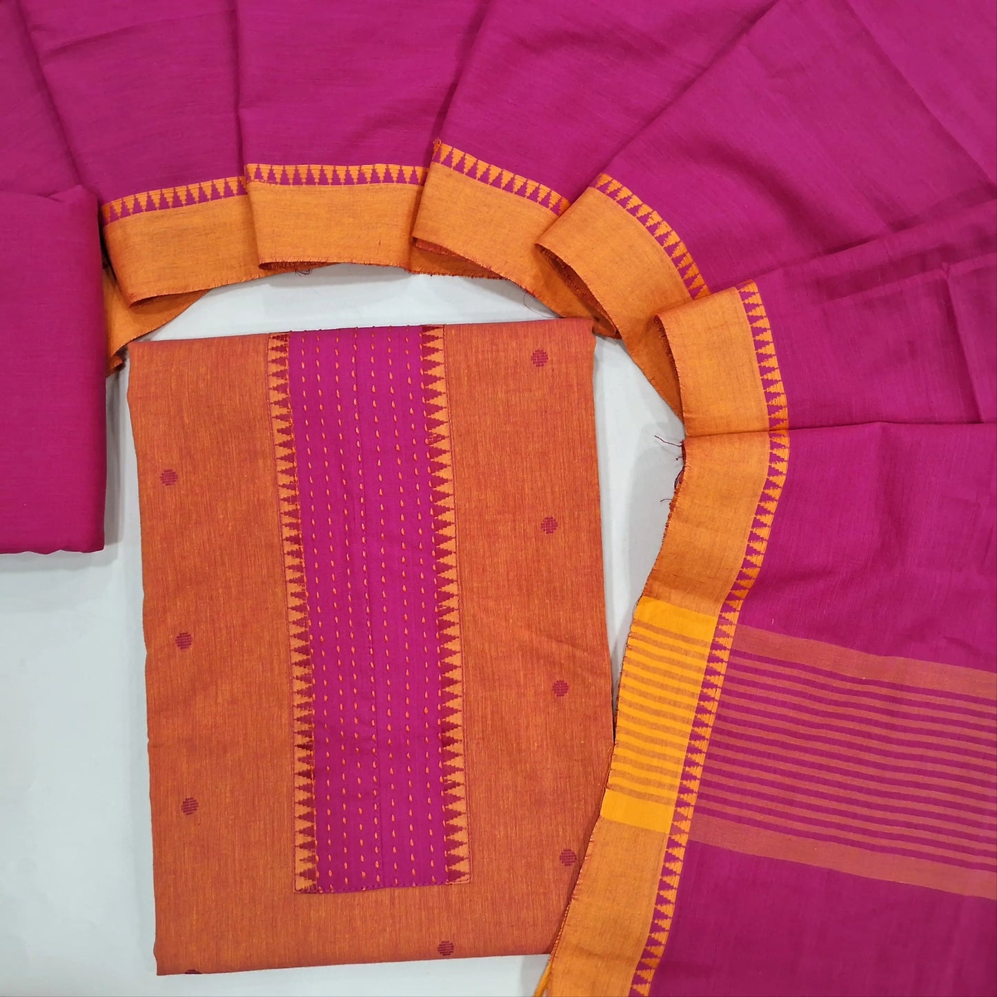 Peachish pink premium handloom cotton unstitched salwar material,kantha stitch work on yoke,thread woven buttas all over(soft,lining optional)bright pink cotton bottom, handloom cotton dupatta with contrast borders. JL260506