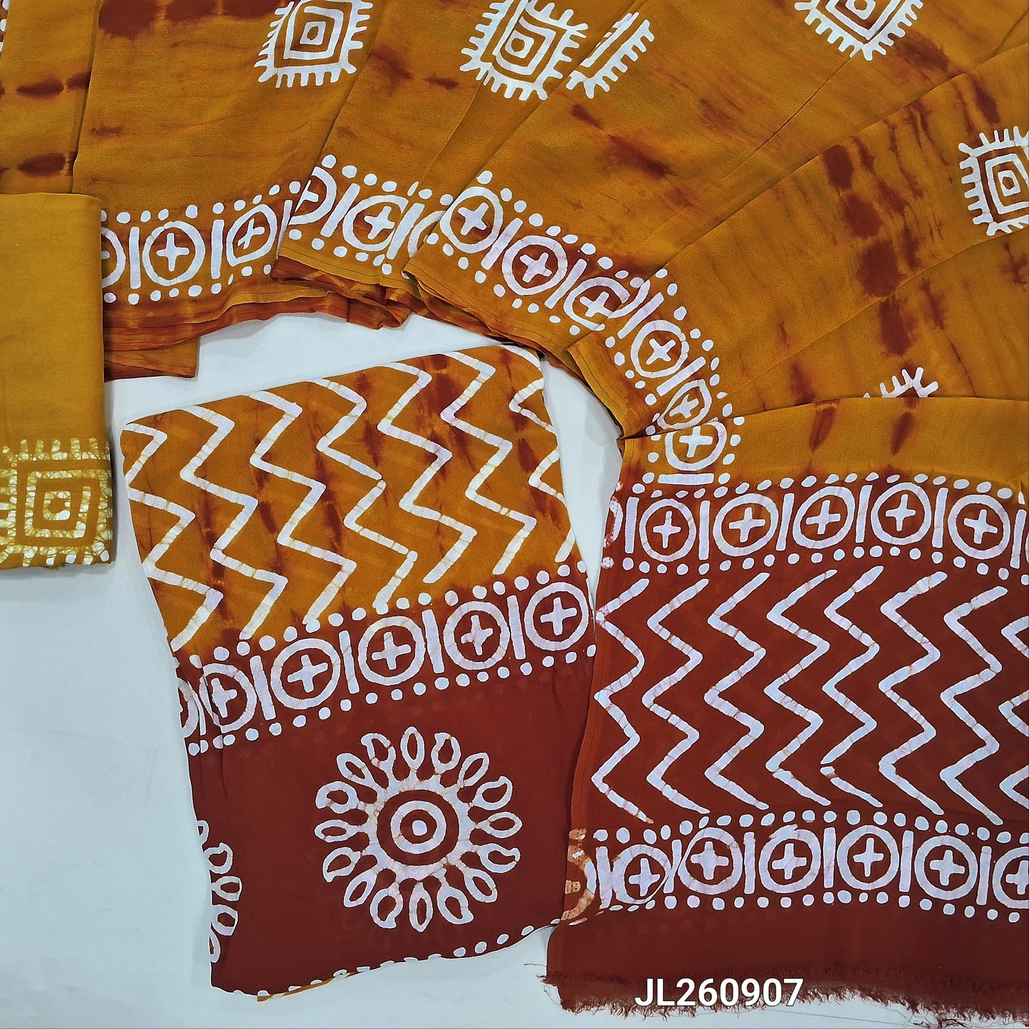 Red & yellow wax batik crepe georgette unstitched salwar material,(lining needed)batik dyed santoon bottom,dual shaded wax batik dyed pure crepe georgette dupatta(TAPPING NEEDED). JL260907