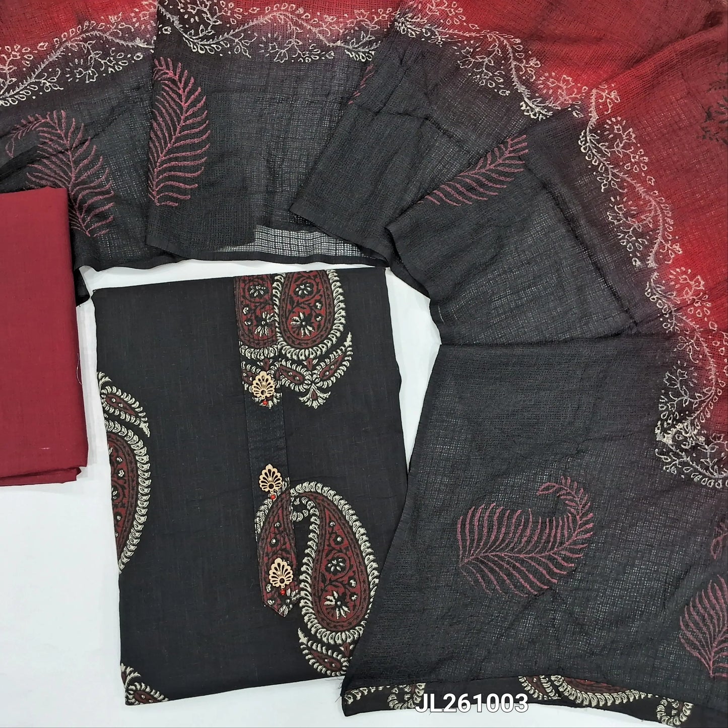 Black printed pure cotton unstitched salwar material,fancy buttons work on yoke,printed all over (lining optional) maroon cotton bottom,dual shade block printed fancy kota silk cotton dupatta.JL261003
