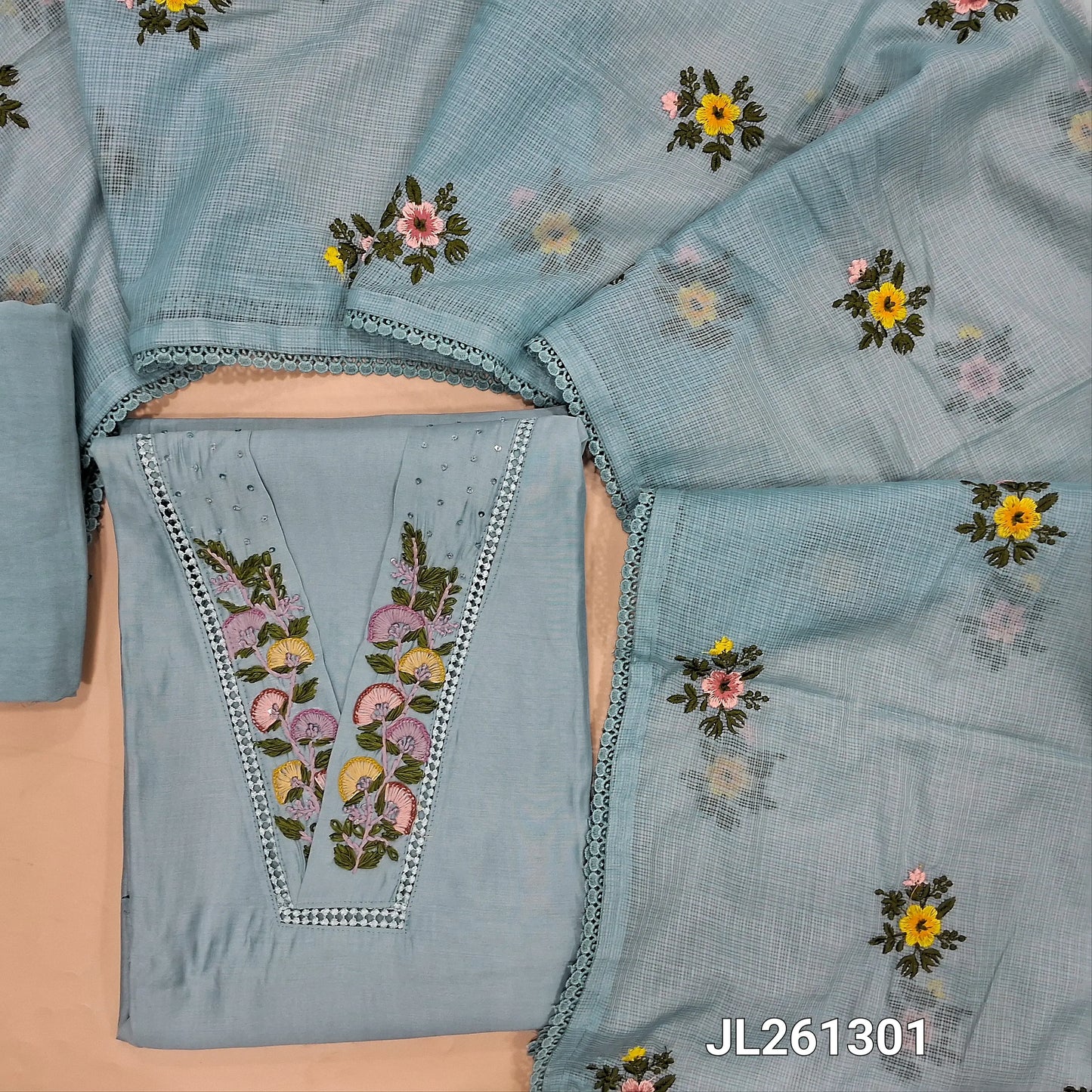 Designer powder blue mul chanderi unstitched salwar material, V neck with hand embroidery and lace work on yoke,(thin, lining needed) spun cotton bottom,thread embroidery work on kota dupatta with lace tapping. JL261301