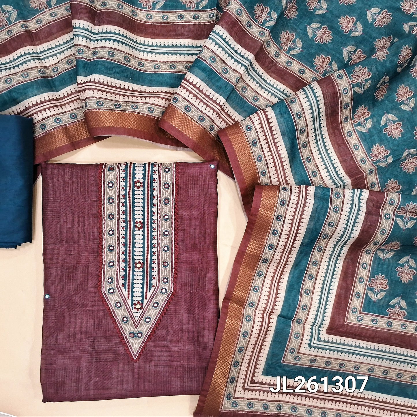 Deep wine purple semi tussar unstitched salwar material, digital printed with thread and faux mirror on yoke,mirror work on front,printed daman border,(Lining needed)teal blue silky bottom,digital printed semi tussar dupatta with zari borders. JL261307