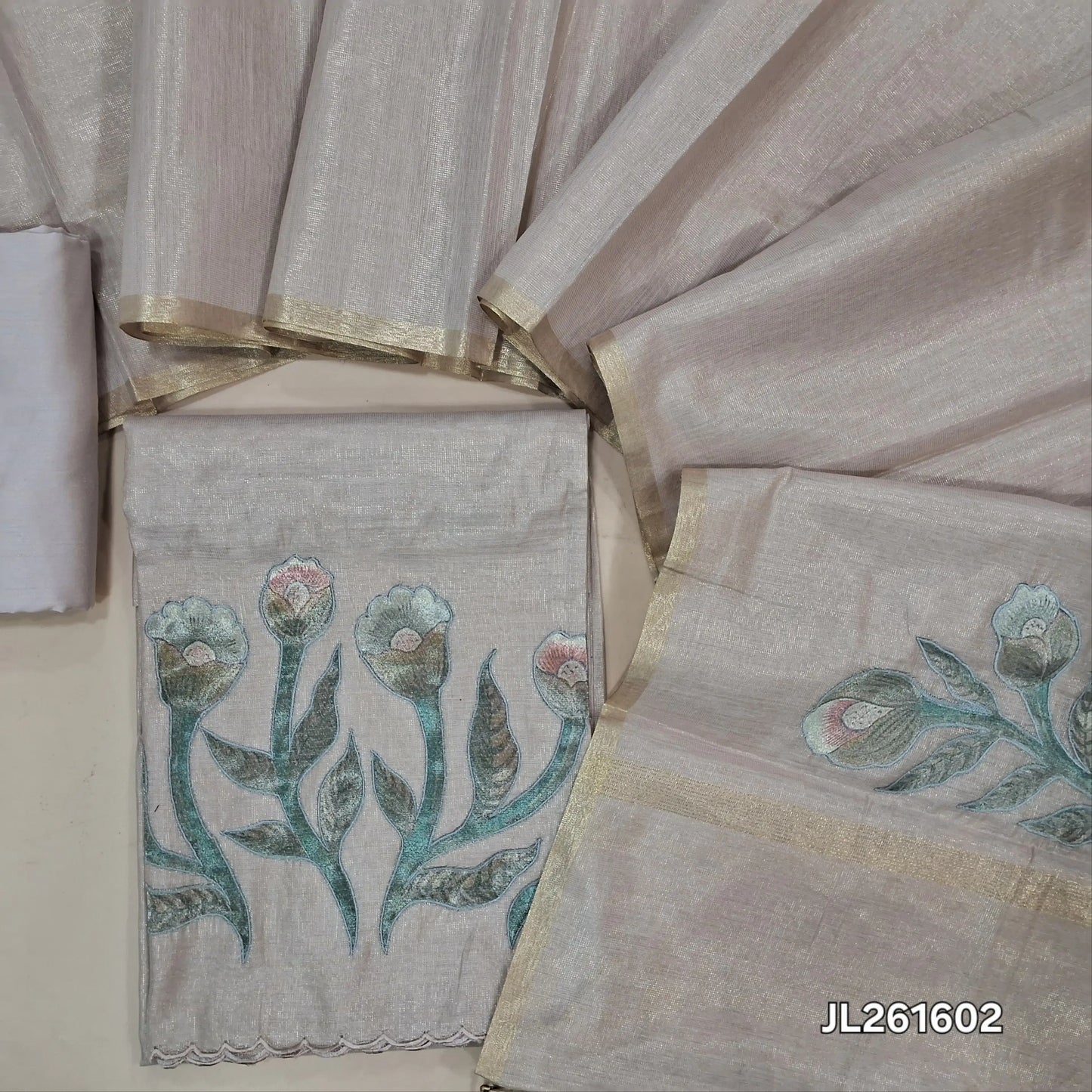 Salmon pink with golden tint tissue silk cotton unstitched salwar material,applique work on daman (thin, lining needed)silk cotton bottom, applique work on full length tissue silk cotton dupatta with gold tissue borders. JL261602