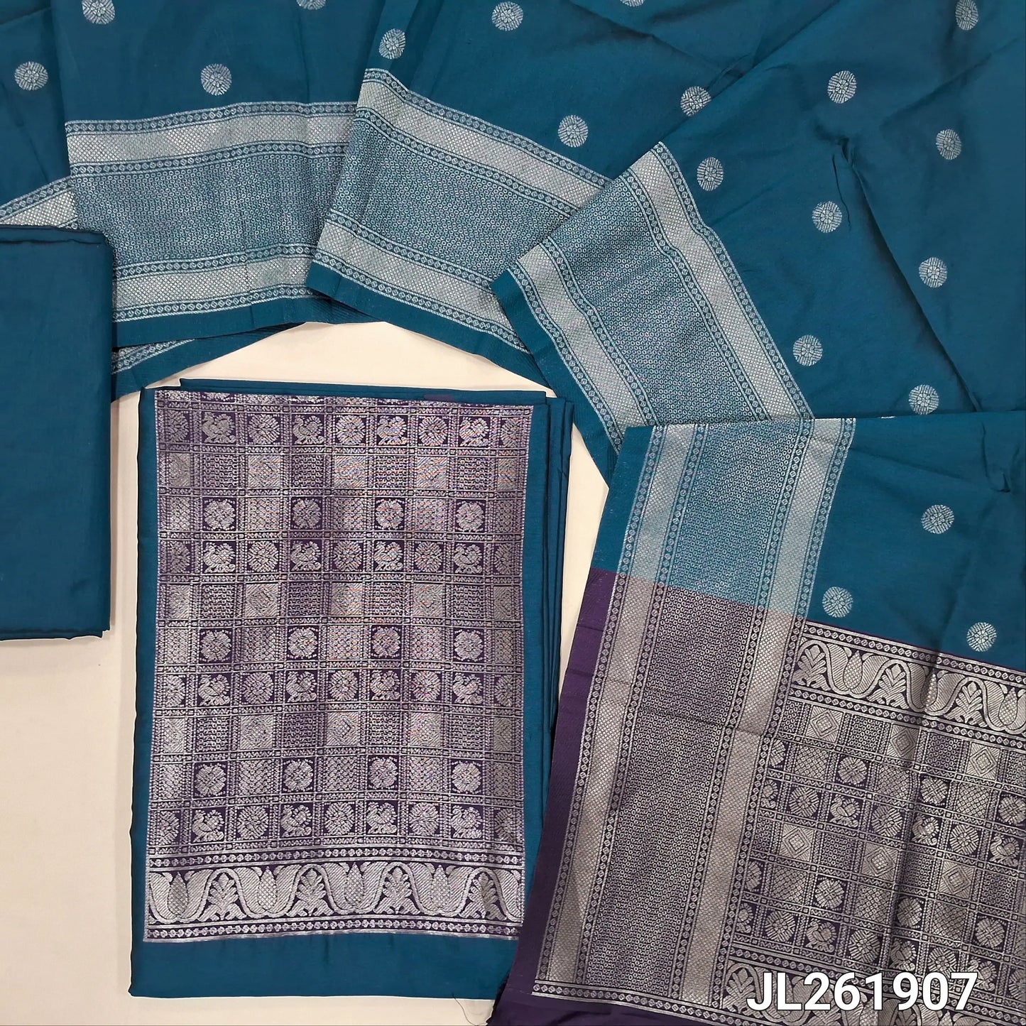 Dark teal blue benarasi silk cotton unstitched salwar material,(PURPLE)brocade weaving yoke patch and daman (lining needed)silk cotton bottom,zari buttas on full length silk cotton dupatta with borders and contrast pallu. JL261907