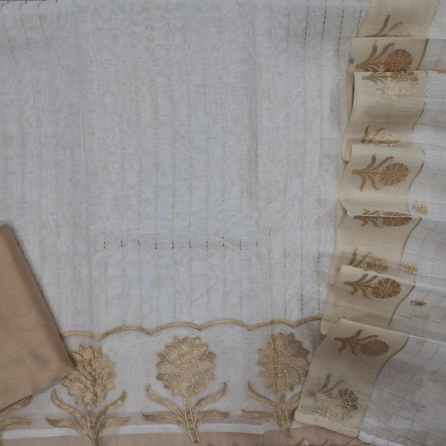 Off white slub silk cotton unstitched salwar material,kantha stitch on front,applique work with organza daman,(lining needed)beige silk cotton bottom, embroidery and zari checks on slub silk cotton dupatta with zari woven borders. JL262112
