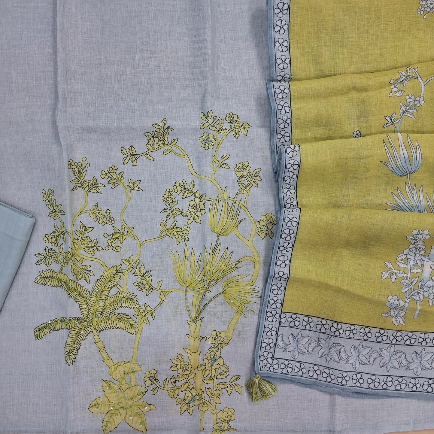 Powder blue premium linen salwar material,V neck printed with bead and sequins work on yoke, rich damna, (textured, lining needed)drum dyed cotton fabric provided for lining, NO BOTTOM,digital printed pure linen with floral printed borders. JL262115