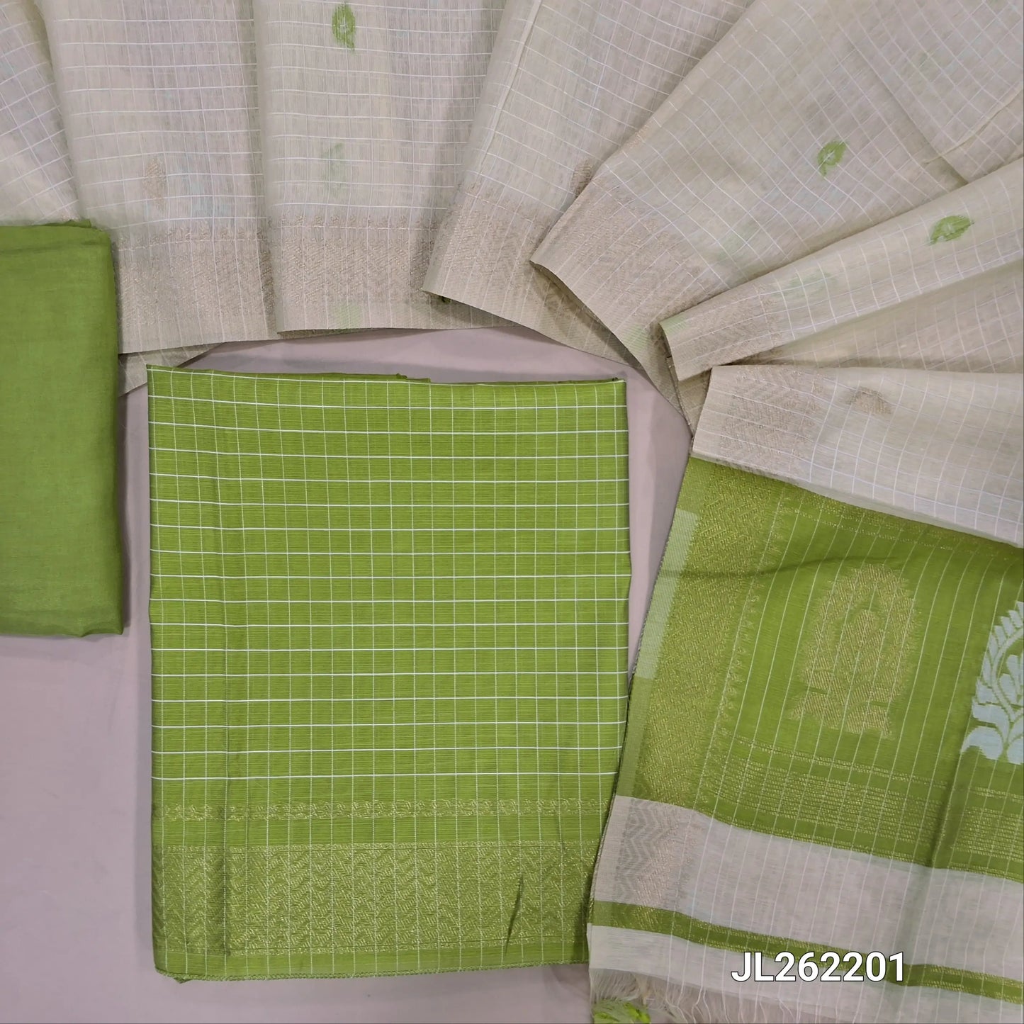 Green shade Viscous Silk cotton unstitched salwar material, self checked design all over, zari wovan borders on daman,(soft, Lining Needed) Santoon Bottom,thread,zari and viscous silk cotton dupatta with tassels and contrast pallu. JL262201