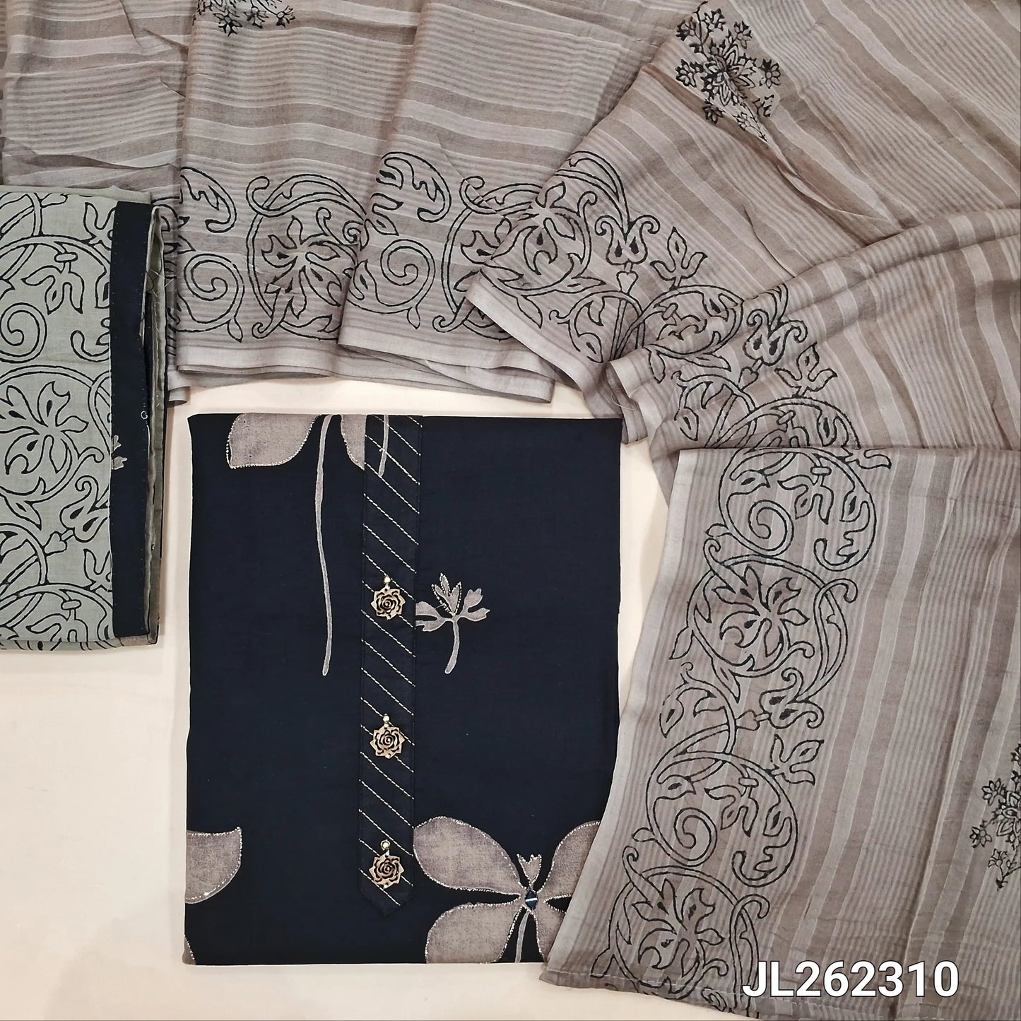 Black floral printed pure cotton unstitched salwar material,fancy buttons work on yoke,(lining optional) block printed greyish beige cotton bottom, block printed mul cotton dupatta. JL262310