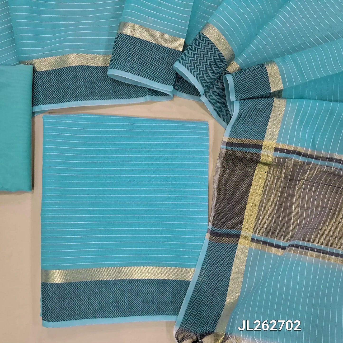 Pastel blue silk cotton unstitched salwar material,thread woven lines all over, thread woven daman,(lining needed)thin silk cotton fabric provided for lining, NO BOTTOM, silk cotton dupatta with gold tissue pallu and thread woven borders. JL262702