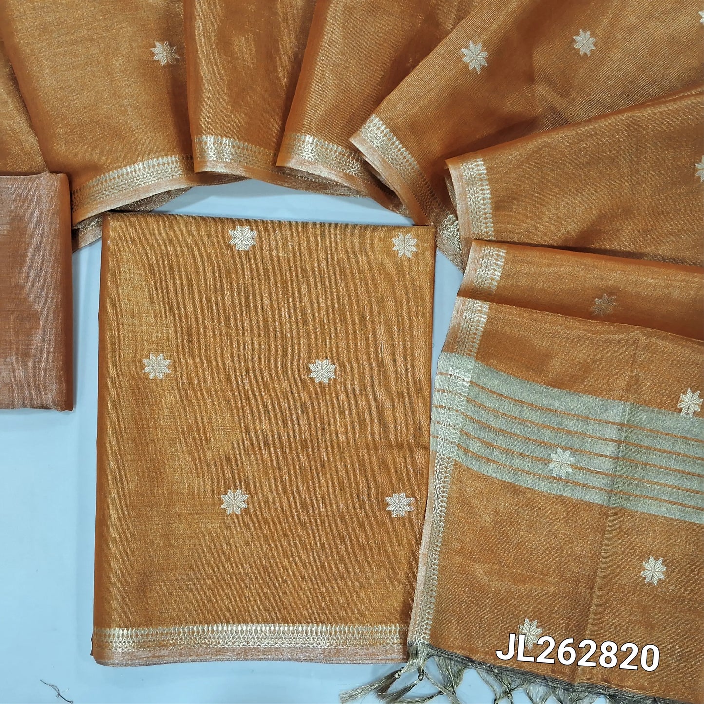 Rust orange with golden tint tissue silk cotton unstitched salwar material, zari buttas all over, zari daman borders, (silky, lining needed)tissue silk cotton bottom, zari buttas on tissue silk cotton dupatta with zari borders. JL262820