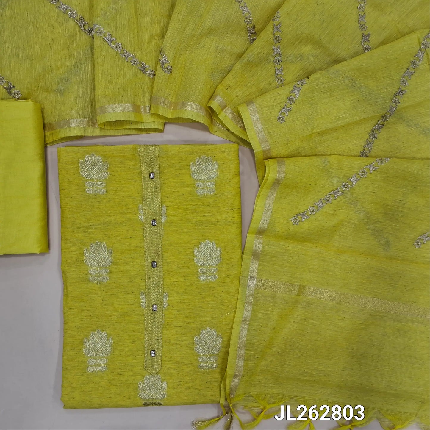 Yellow slub silk unstitched salwar material,benarasi zari woven all over, simple yoke, (lining needed)silky bottom, zari embroidery onslub silk dupatta with tissue borders. JL262803