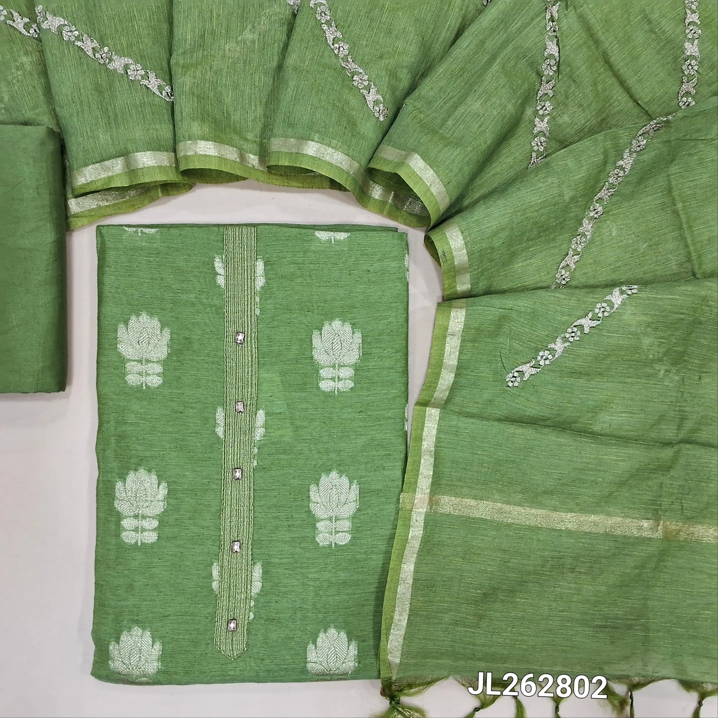 Leafy green slub silk unstitched salwar material,benarasi zari woven all over, simple yoke, (lining needed)silky bottom, zari embroidery onslub silk dupatta with tissue borders. JL262802