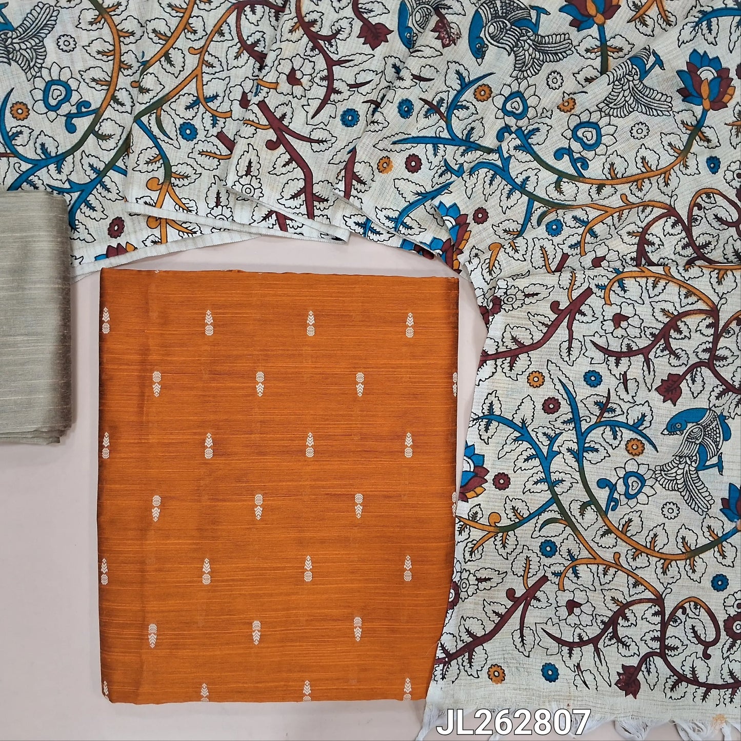 Rust orange slub silk cotton unstitched salwar material, thread woven buttas all over,(textured,lining needed)beige silk cotton bottom, floral and peacock printed jute cotton dupatta. JL262807