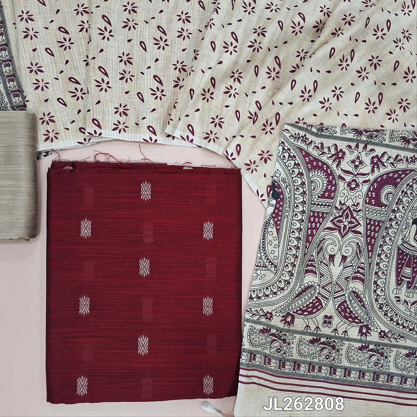 Pinkish maroon slub silk cotton unstitched salwar material, thread woven buttas all over,(textured,lining needed)beige silk cotton bottom, madhubani printed jute cotton dupatta. JL262808