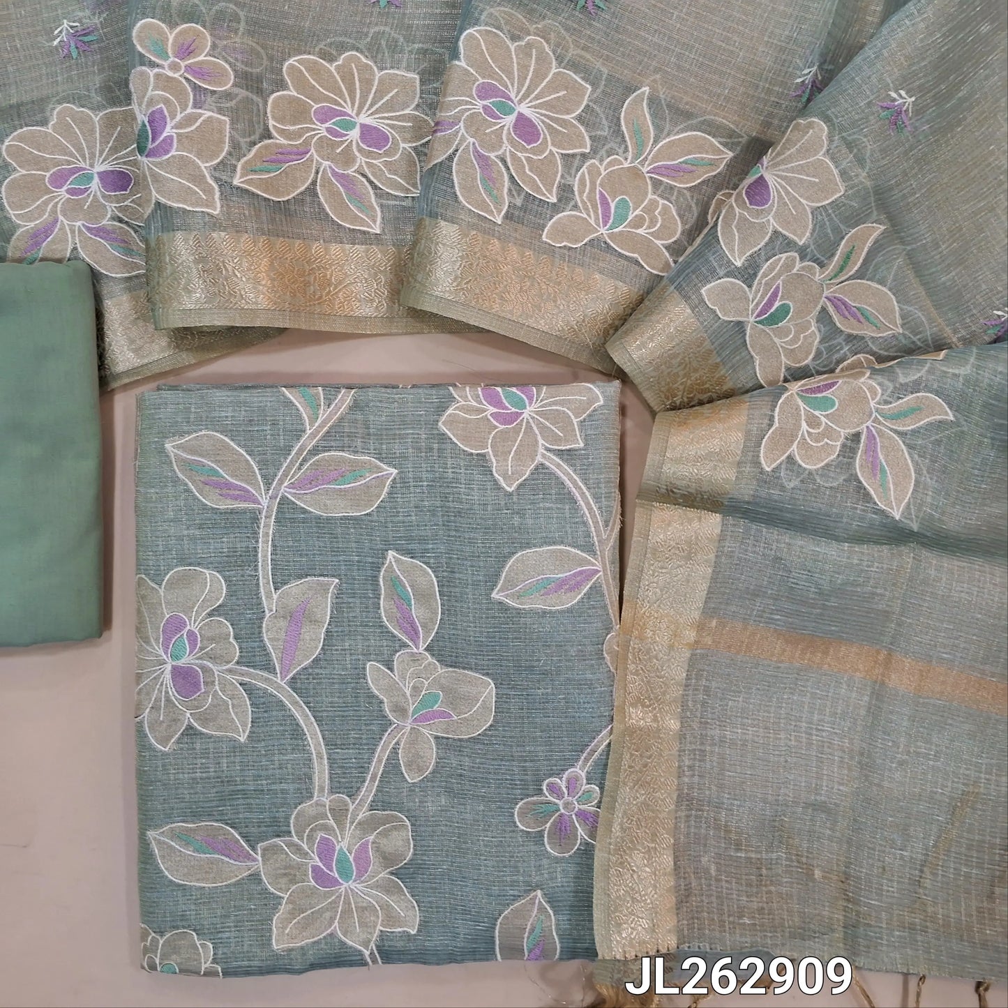 Ice blue golden tint premium tissue kota unstitched salwar material, applique work and thread embroidery on front, (lining needed)cotton/silk cotton bottom,embroidery on tissue kota dupatta with applique work and zari borders. JL262909