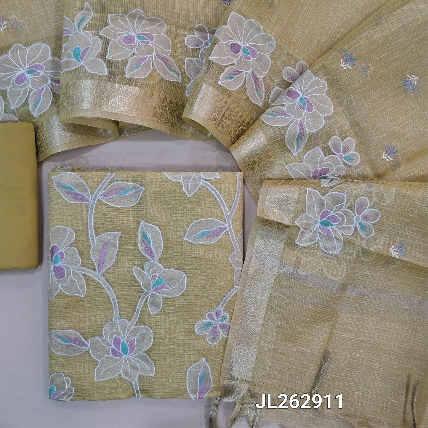 Pastel yellow golden tint premium tissue kota unstitched salwar material, applique work and thread embroidery on front, (lining needed)cotton/silk cotton bottom,embroidery on tissue kota dupatta with applique work and zari borders. JL262911