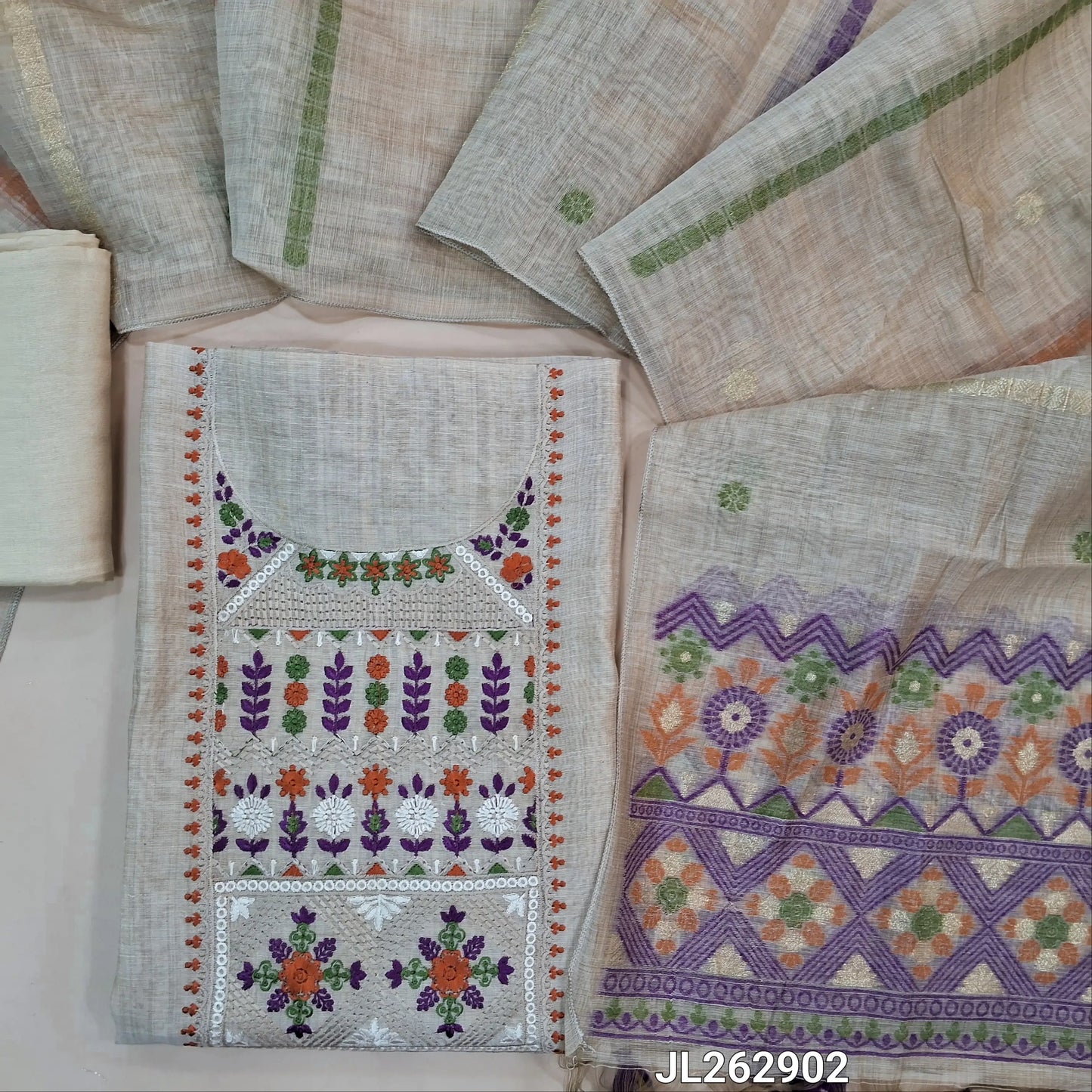 Designer beige base silk cotton unstitched salwar material, thread embroidery on yoke,(ORANGE/PURPLE) (lining needed) santoon bottom, jamdani woven silk cotton dupatta with pallu and handmade tassles. JL262902