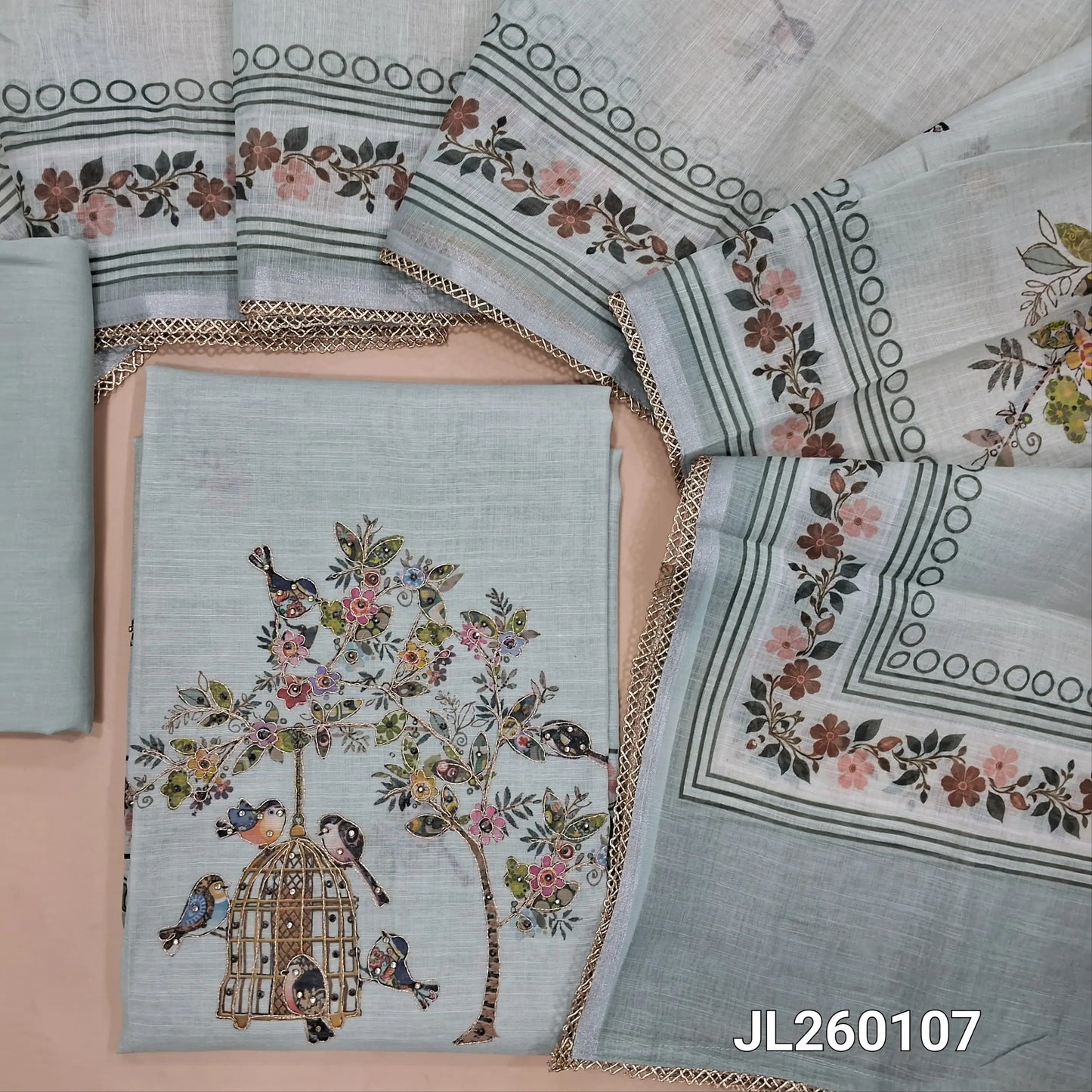 Pastel blue semi linen unstitched salwar material,printed all over,colorful digital printed with zarodzi and sequins on yoke,(lining needed)drum dyed cotton bottom,digital printed semi linen dupatta with lace tapping. AG260107