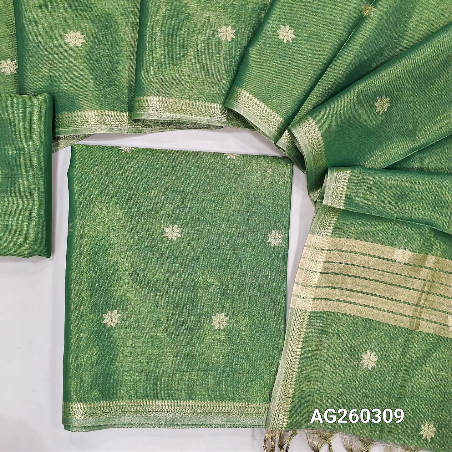 Leafy green with golden tint tissue silk cotton unstitched salwar material, zari buttas all over, zari daman borders, (silky, lining needed)tissue silk cotton bottom, zari buttas on tissue silk cotton dupatta with zari borders. AG260309