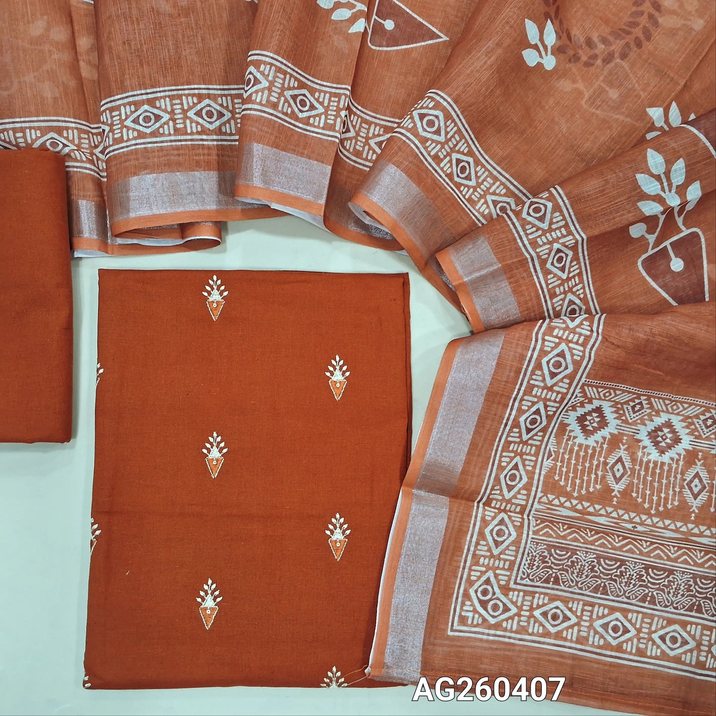 Brick red pure cotton unstitched salwar material,embroidery on front,(lining optional) cotton bottom, printed on semi linen dupatta with silver tissue borders. AG260407
