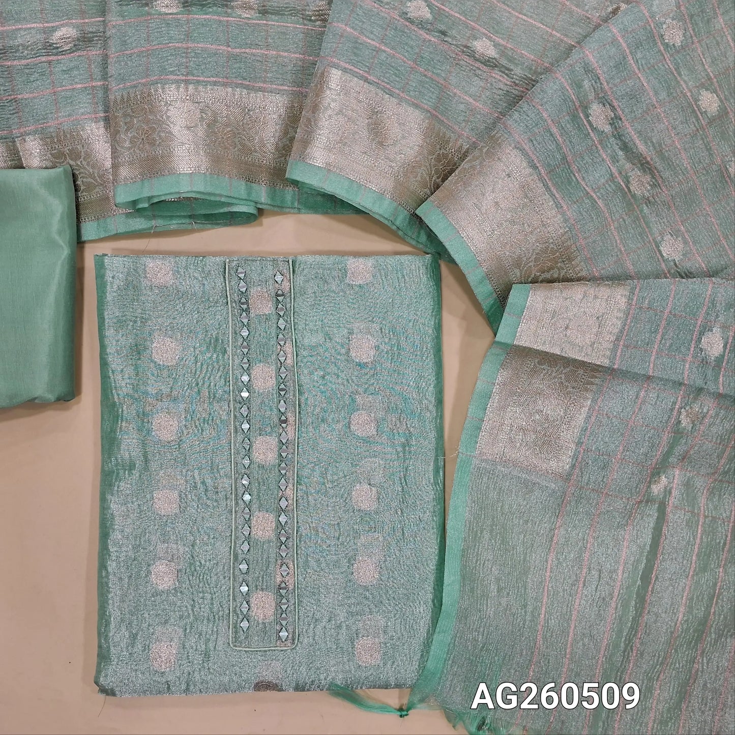 Pastel blue with golden tint crinkled tissue silk cotton unstitched salwar material,mirror on yoke, buttas all over,(thin, lining needed)silky/silk cotton bottom, zari woven and vertical design on crinkled tissue silk cotton dupatta with borders. AG260509