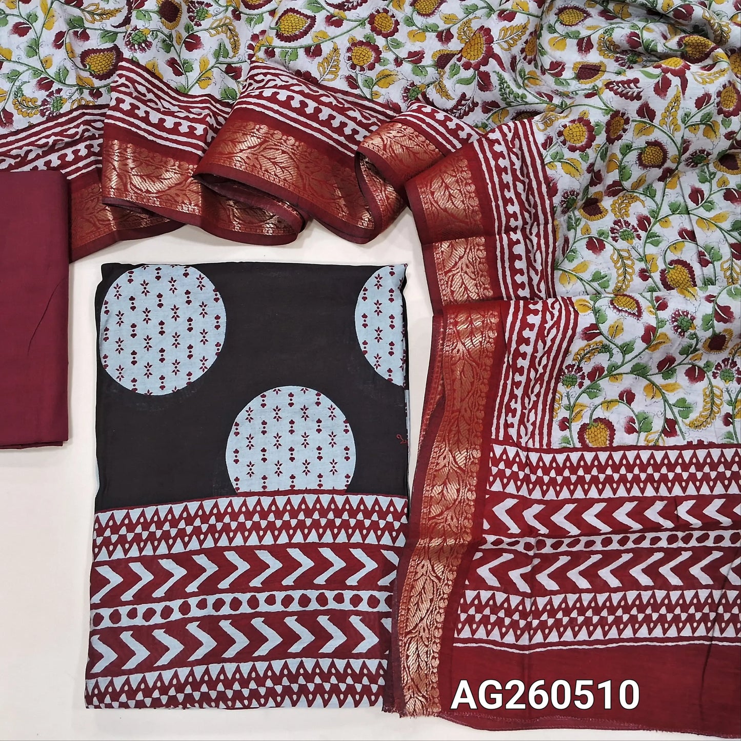 Black base soft silk cotton unstitched salwar material,polka design, printed all over,(lining needed)reddish maroon cotton bottom,floral printed silk cotton dupatta with borders and pallu. AG260510