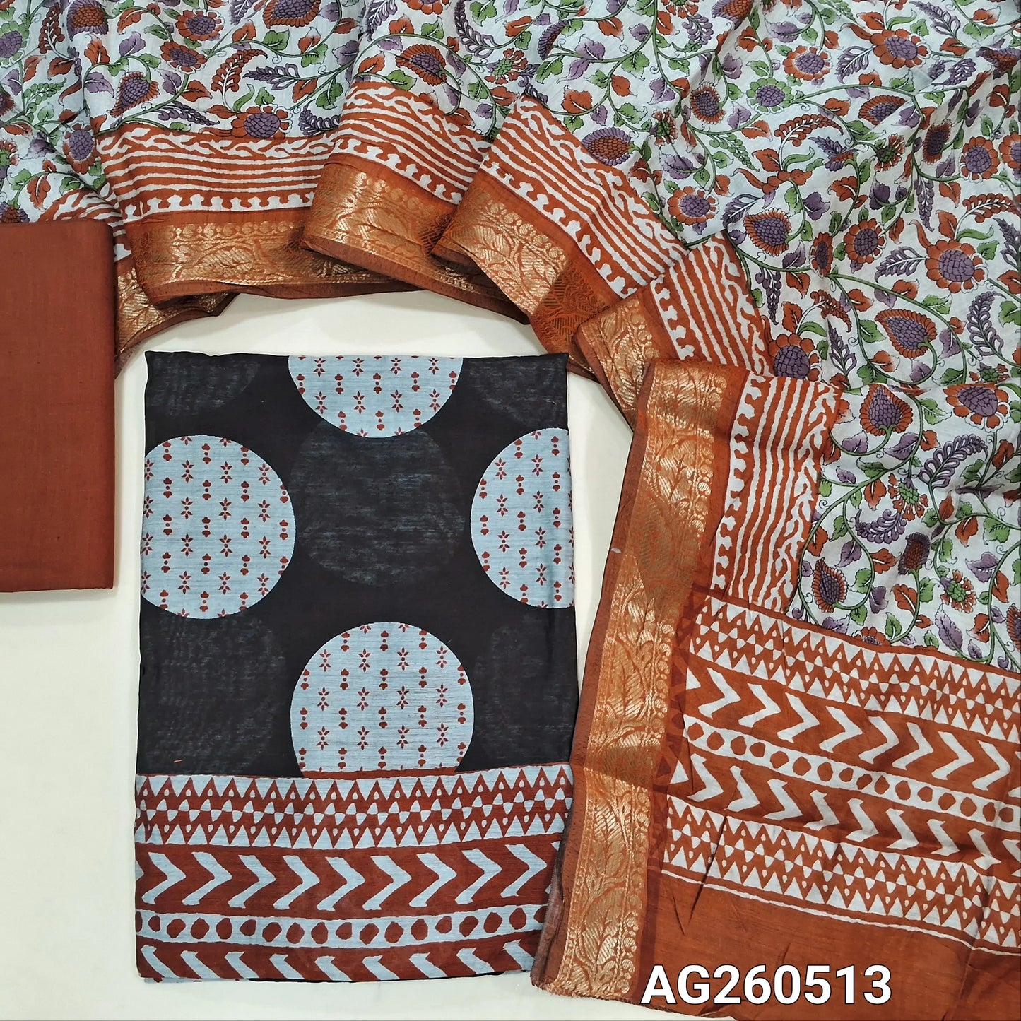 Black base soft silk cotton unstitched salwar material,polka design, printed all over,(lining needed)brick red cotton bottom,floral printed silk cotton dupatta with borders and pallu. AG260513