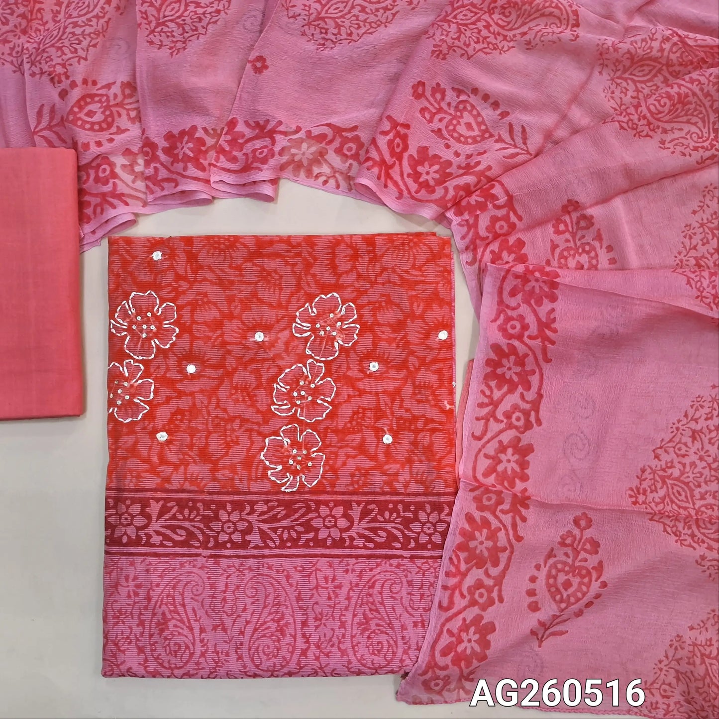 Light & dark peachish pink hand block printed premium kota unstitched salwar material, mirror & floral printed with hand embroidery work on yoke,(Lining Needed)cotton bottom,dual shaded hand block printed chiffon dupatta. AG260516