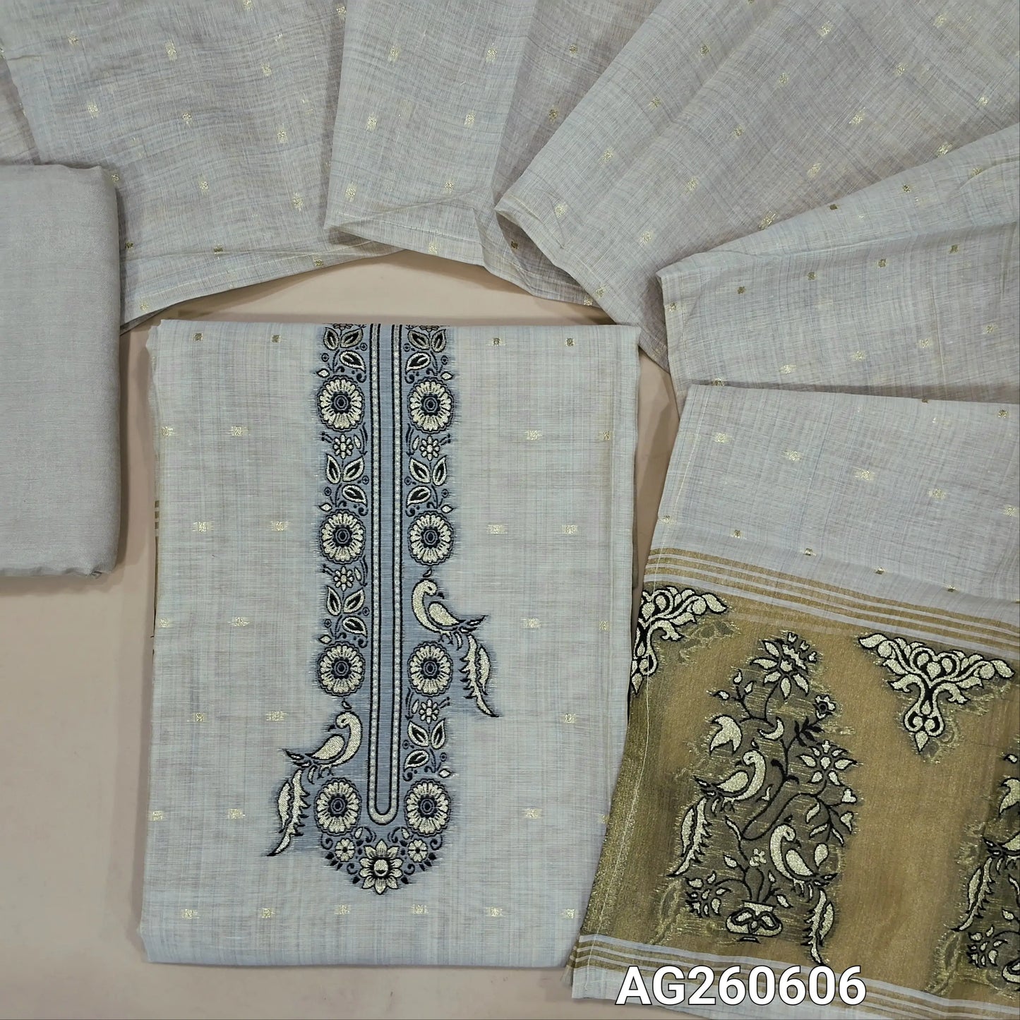 Rich beige premium silk cotton unstitched salwar material,thread and zari weaving on yoke, zari buttas all over,gold tissue with zari weaving daman,(lining needed)santoon bottom,soft silk cotton dupatta with gold tissue pallu. AG260606
