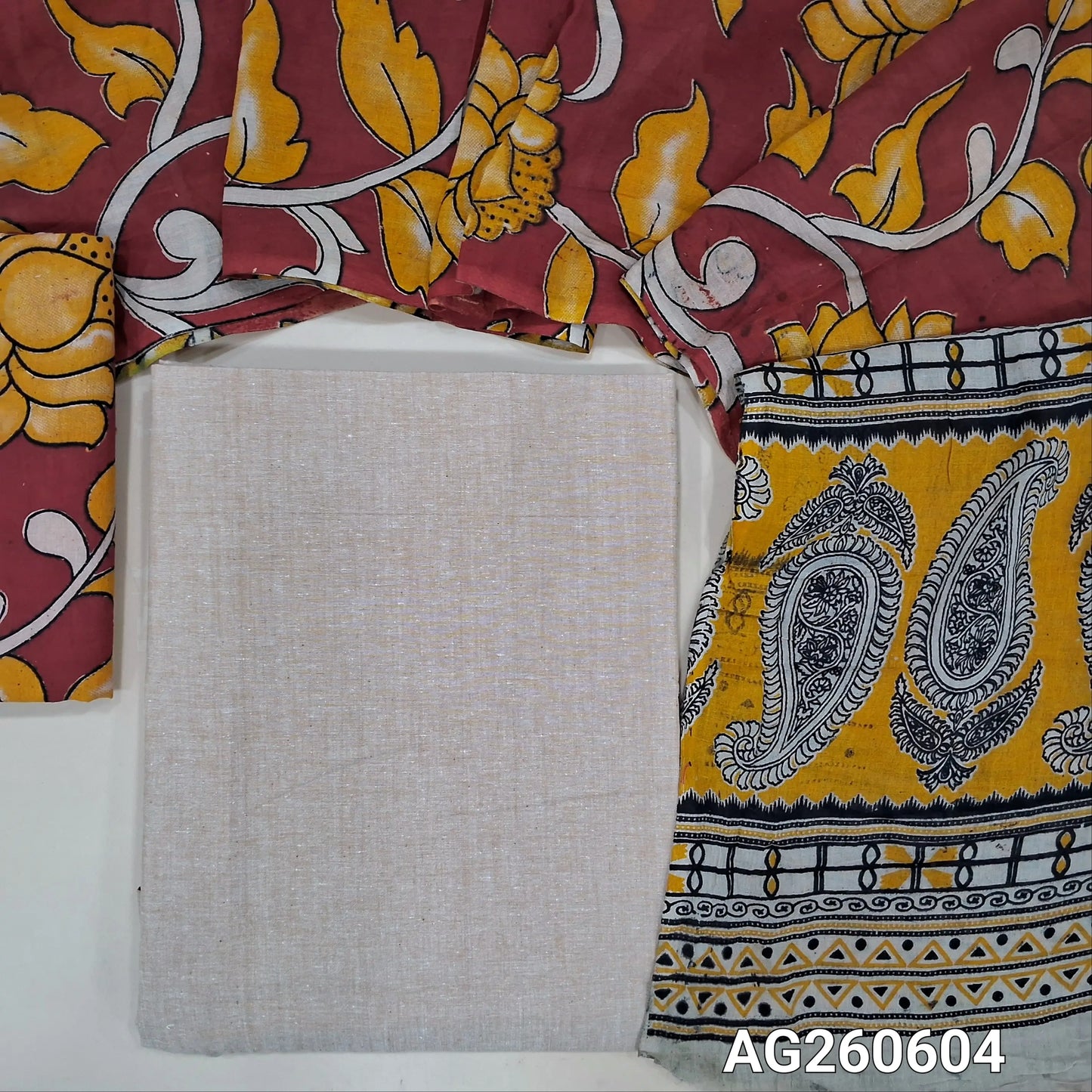 Beige handloom cotton unstitched salwar material,(lining optional)reddish maroon kalamkari hand block printed cotton bottom,kalamkari hand block printed mul cotton dupatta with contrast pallu. AG260604