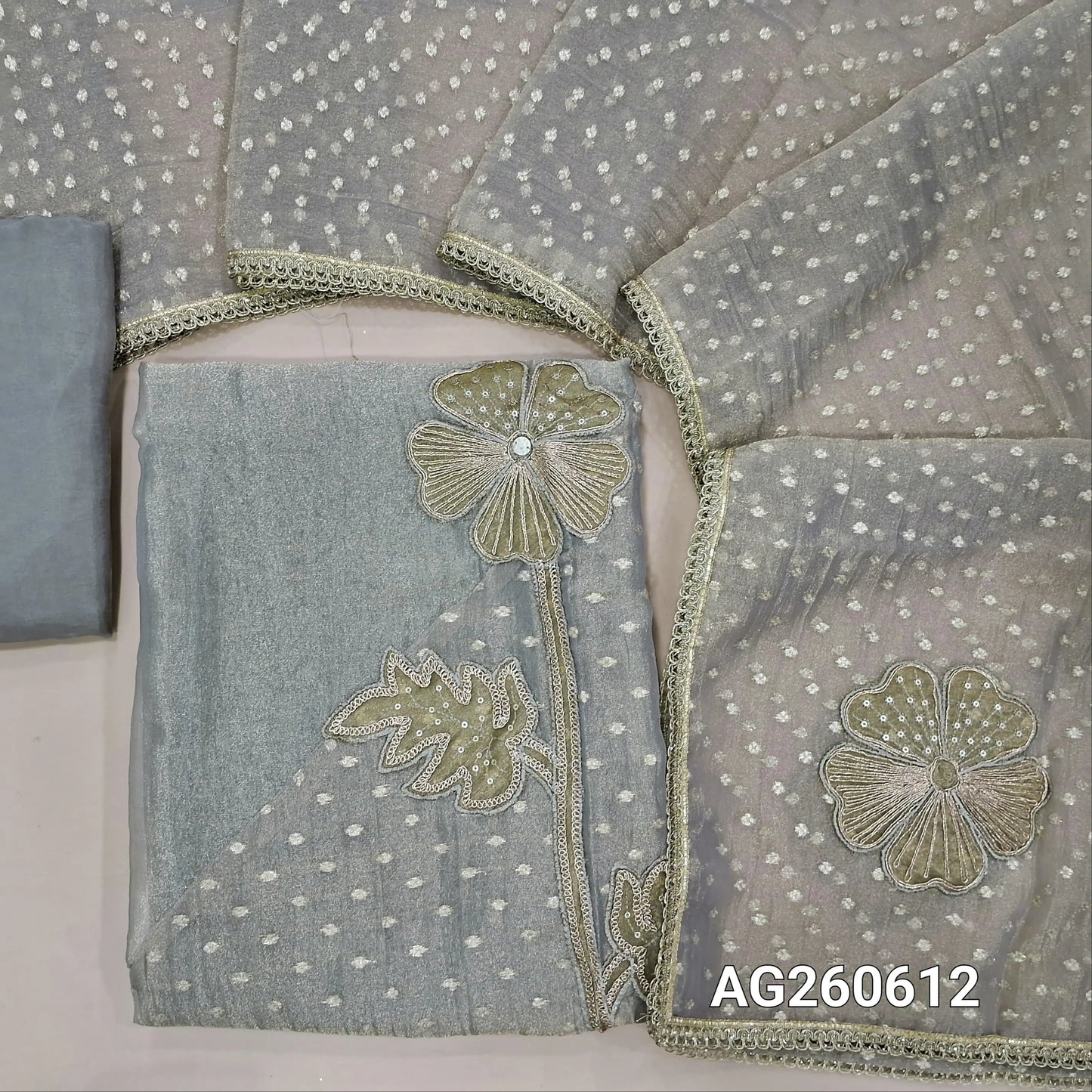 Silver grey with golden tint crinkled tissue organza unstitched salwar material,applique with zari and sequins on daman,(thin, lining needed)silky bottom,benarasi zari woven and applique work on tissue organza dupatta with lace tapping. AG260612