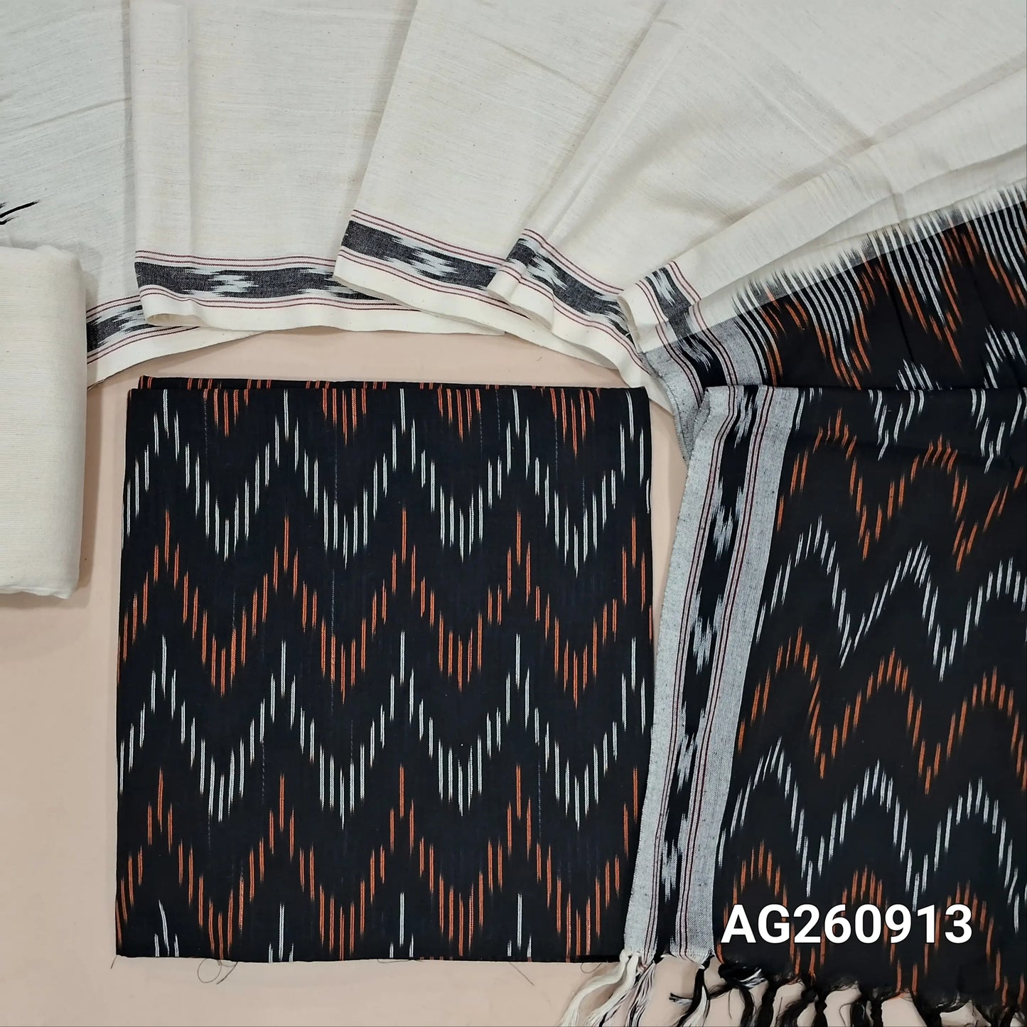 Black premium ikat woven handloom cotton unstitched salwar material, (lining optional)off white cotton bottom, dual shaded handloom cotton dupatta with borders and tassles. AG260913