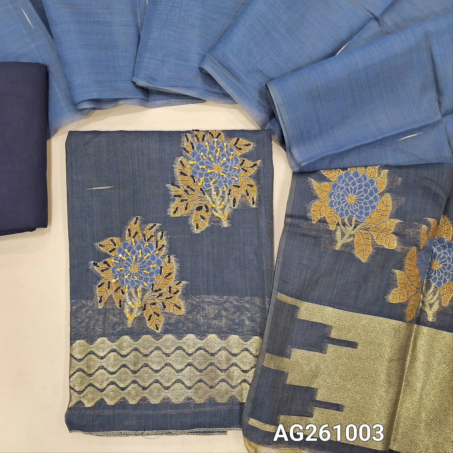 Dark grey silk cotton unstitched salwar material,thread woven lines on front, thread and zari work with thread work daman,(Lining Needed)spun cotton bottom, dual shaded full length silk cotton dupatta with rich pallu and tassles. AG261003