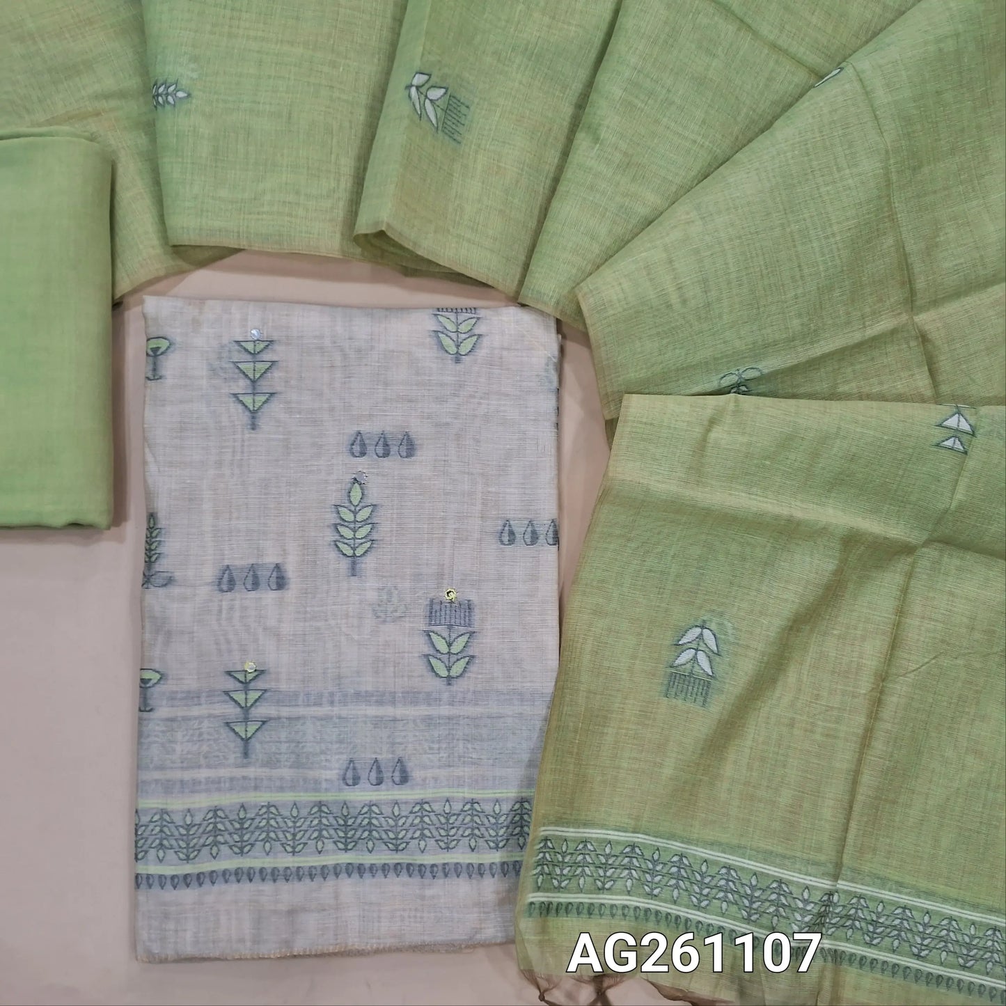 Beige silk cotton unstitched salwar material, faux mirror and thread weaving on front,(Lining Needed)green santoon bottom,thread wevaing on silk cotton dupatta with borders. AG261107