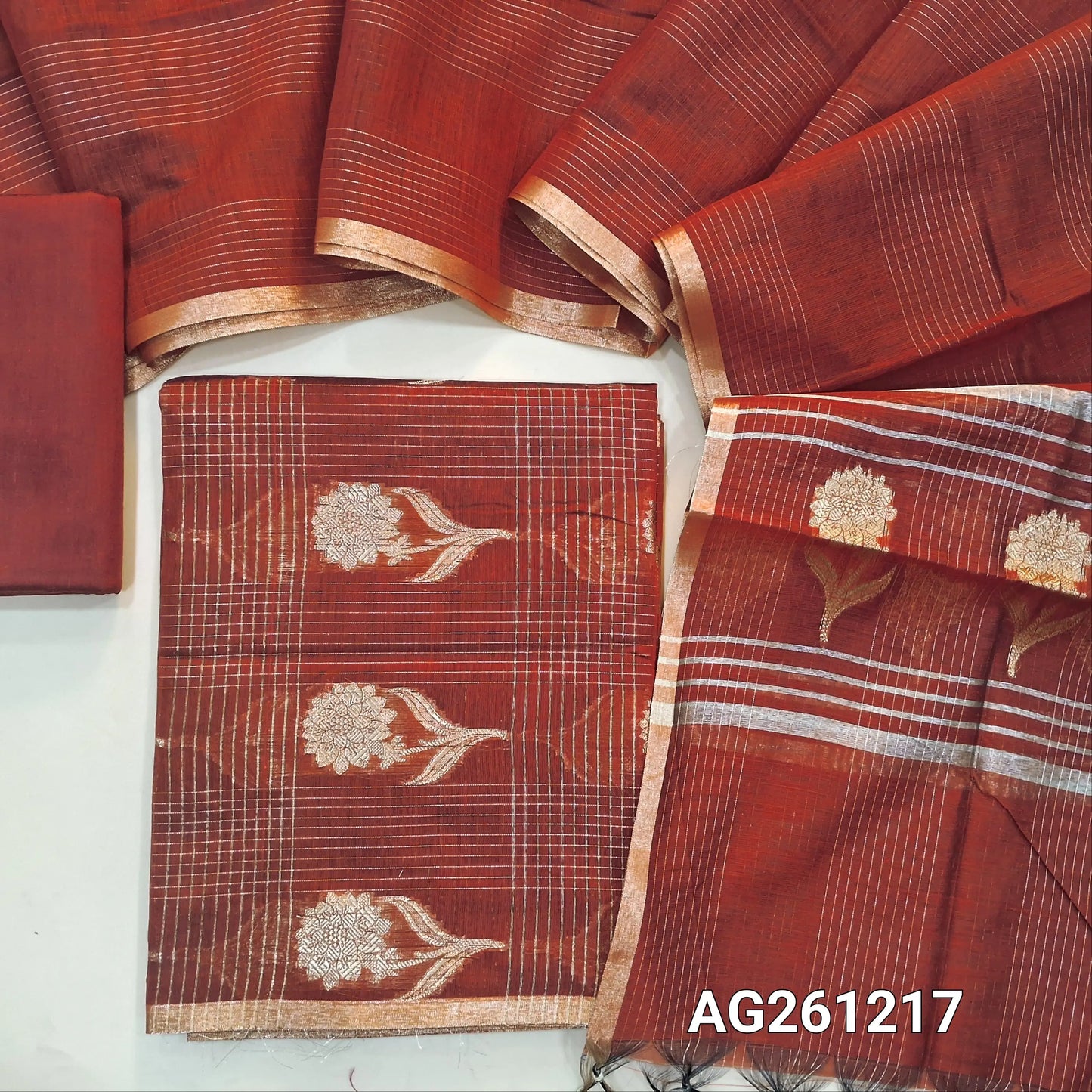 Reddish maroon benarasi silk cotton unstitched salwar material,checked and floral zari weaving all over(Lining Needed)silk cotton bottom,vertical zari lines on silk cotton dupatta with floral weaving pallu and tassles. AG261217