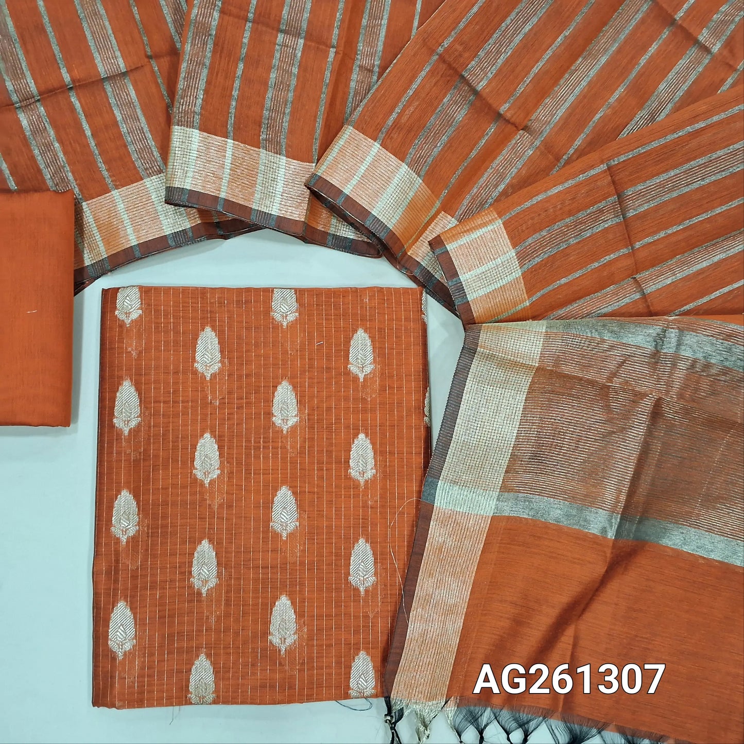 Rust orange benarasi silk cotton unstitched salwar material,zari woven buttas and zari lines all over,gold tissue daman,(Lining Needed)silk cotton bottom, gold tissue lines on tissue silk cotton dupatta with borders. AG261307