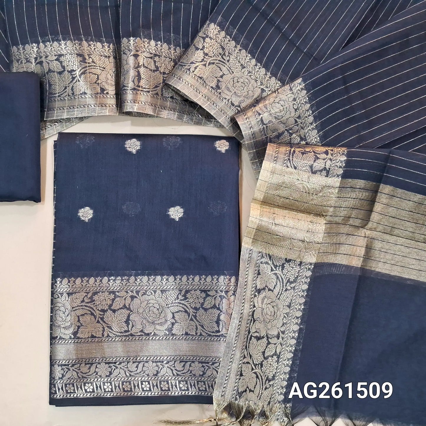 Dark blue benarasi silk cotton unstitched salwar material,checked design on yoke,buttas on front,antic gold zari weaving daman,(Lining Needed)silk cotton bottom,zari lines on silk cototn dupatta with tissue pallu and borders. AG261509
