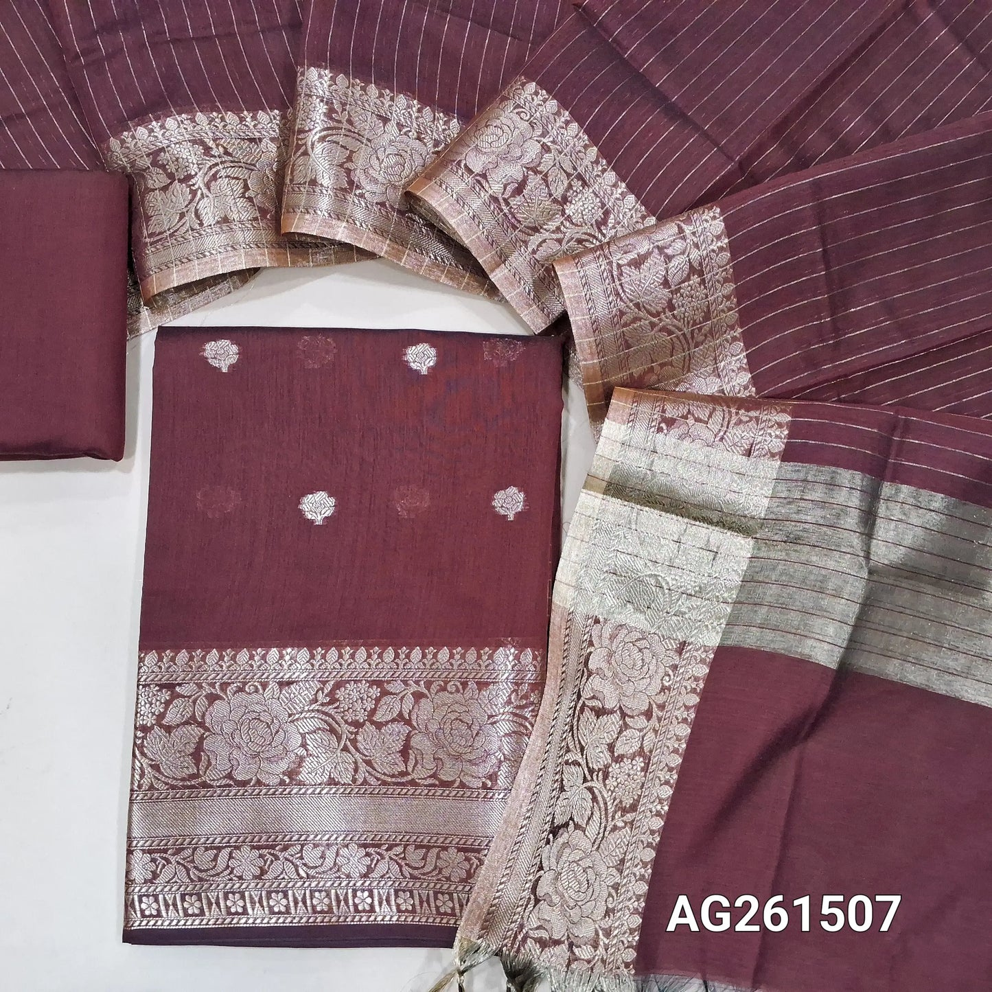 Dark maroon benarasi silk cotton unstitched salwar material,checked design on yoke,buttas on front,antic gold zari weaving daman,(Lining Needed)silk cotton bottom,zari lines on silk cotton dupatta with tissue pallu and borders. AG261507